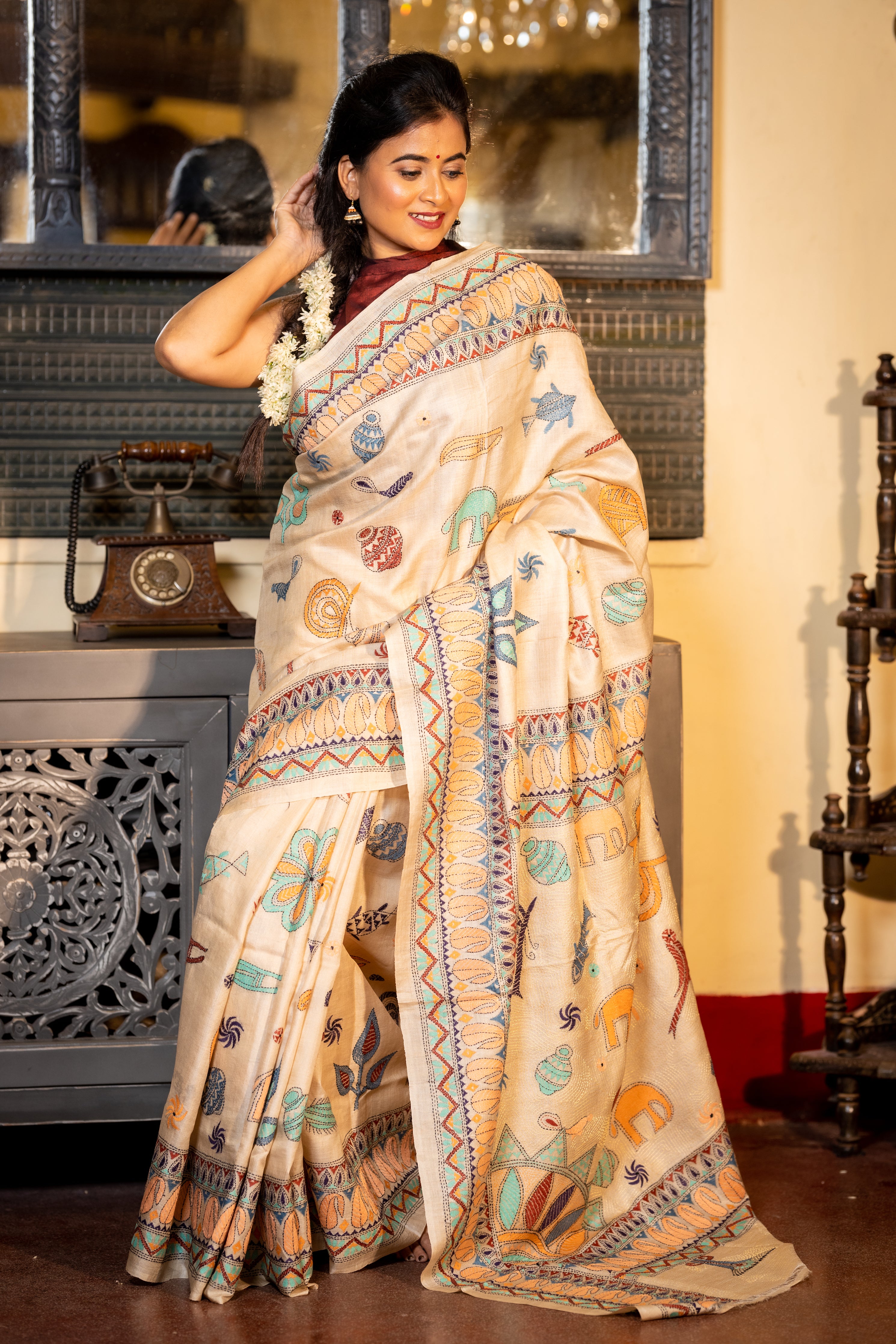 Mrittika || Light Beige Pure Gachhi Tussar Silk Handloom Kantha Stitch Embroidery Saree with all over Multi-colour Mixed Tribal Art motifs and Golden Resham highlights Pallu
