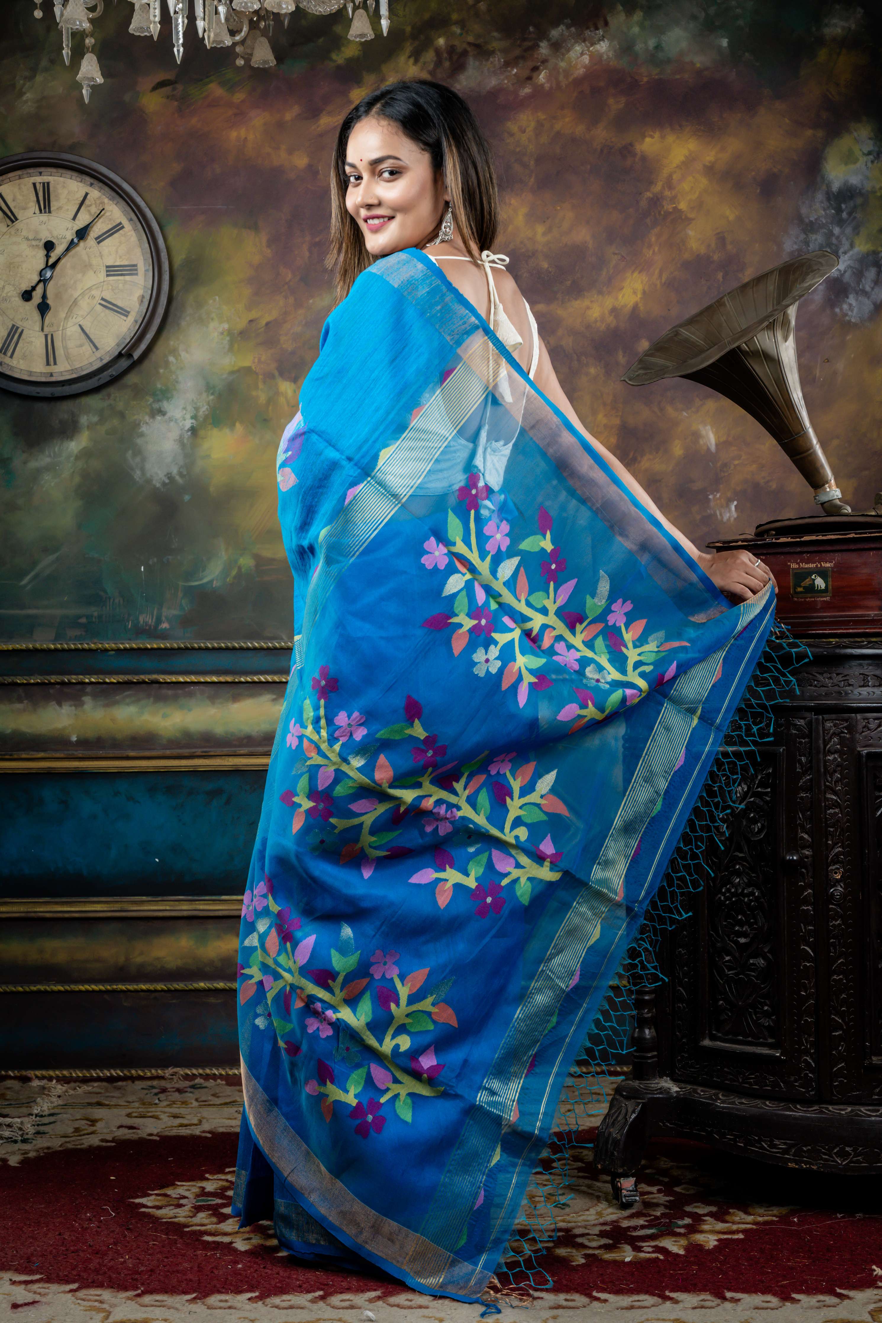 Nila || Cerulean Blue Premium 'Matka-Muslin' Bengal Handloom Saree with all over Multi-colour Floral Jamdani Buta on Matka body & Muslin Pallu with Golden Zari highlights