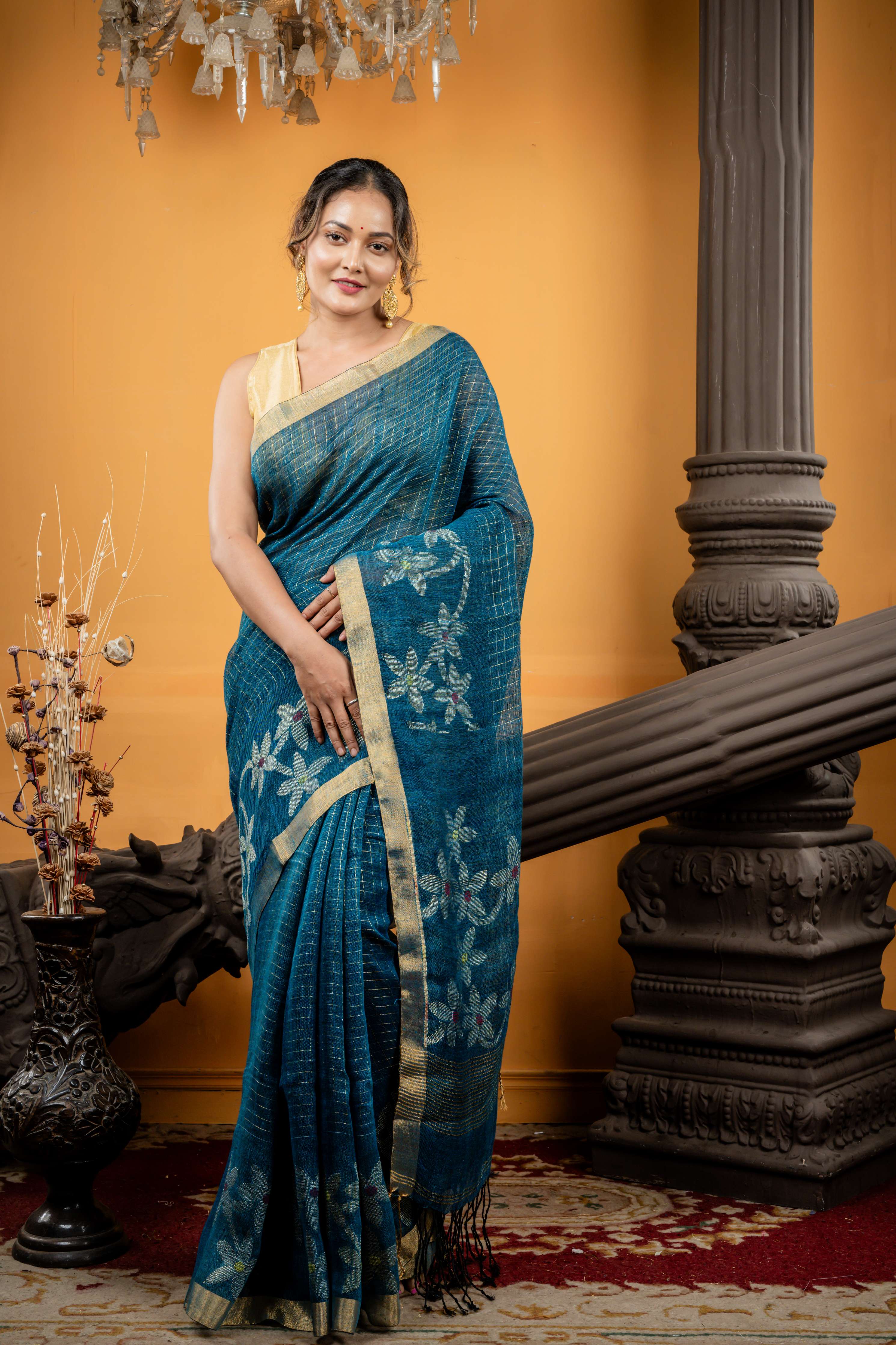 Shalini || Peacock Blue & Black dual tone Linen Bengal Handloom Saree with all over Golden Zari Checks & Floral Pallu with Multi-colour Buti and Antique Gold Zari Border