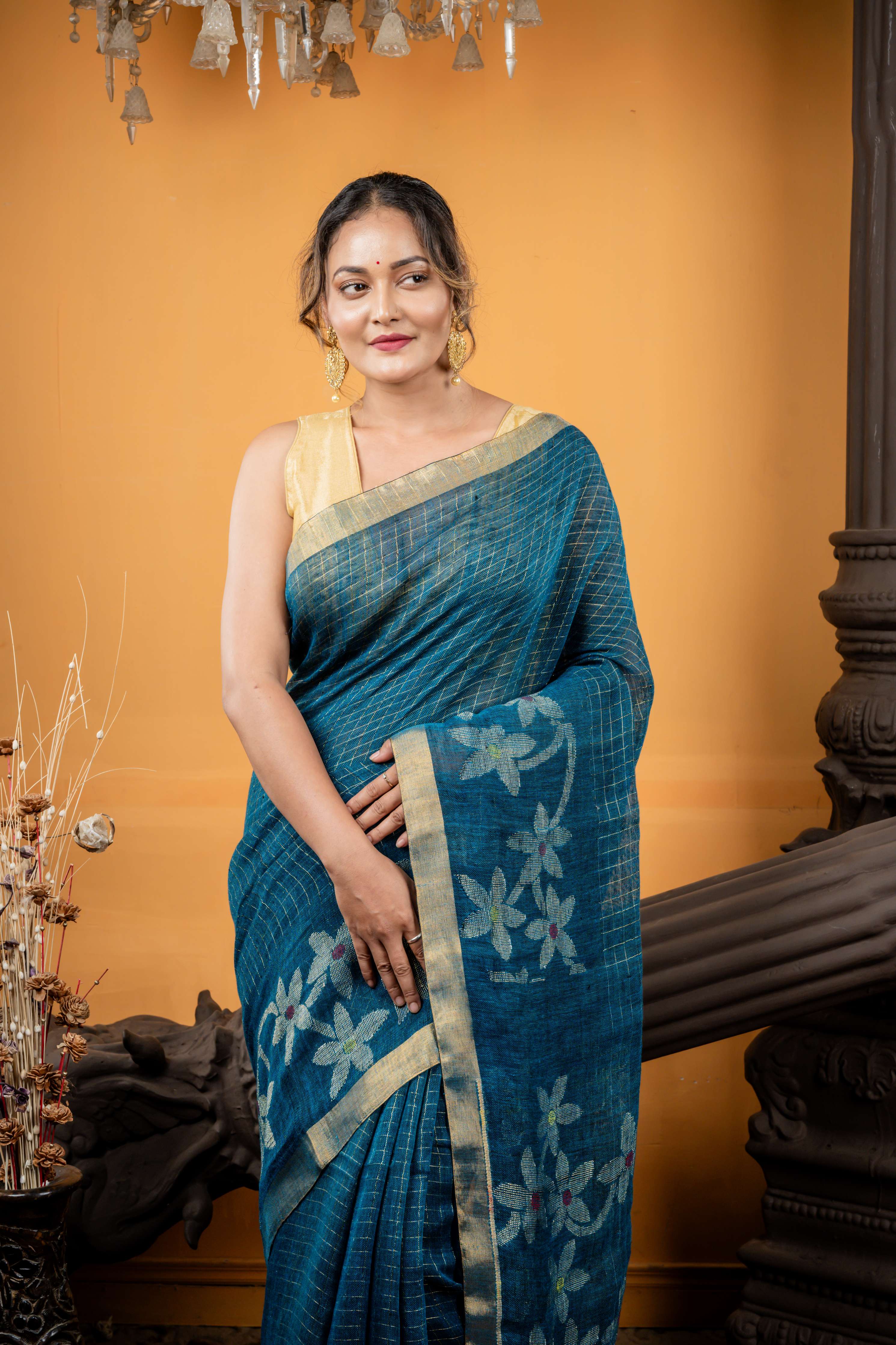 Shalini || Peacock Blue & Black dual tone Linen Bengal Handloom Saree with all over Golden Zari Checks & Floral Pallu with Multi-colour Buti and Antique Gold Zari Border