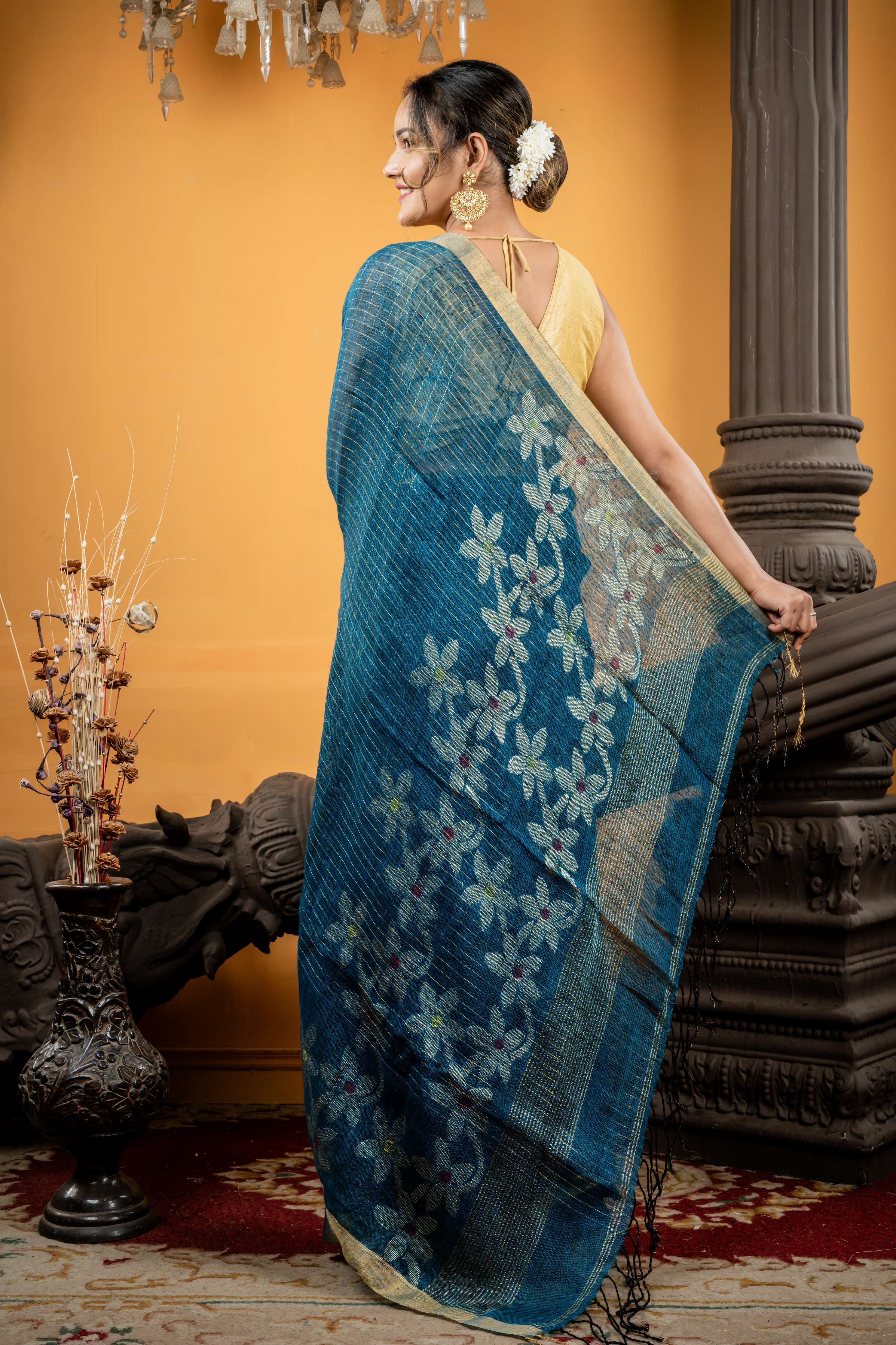 Shalini || Peacock Blue & Black dual tone Linen Bengal Handloom Saree with all over Golden Zari Checks & Floral Pallu with Multi-colour Buti and Antique Gold Zari Border