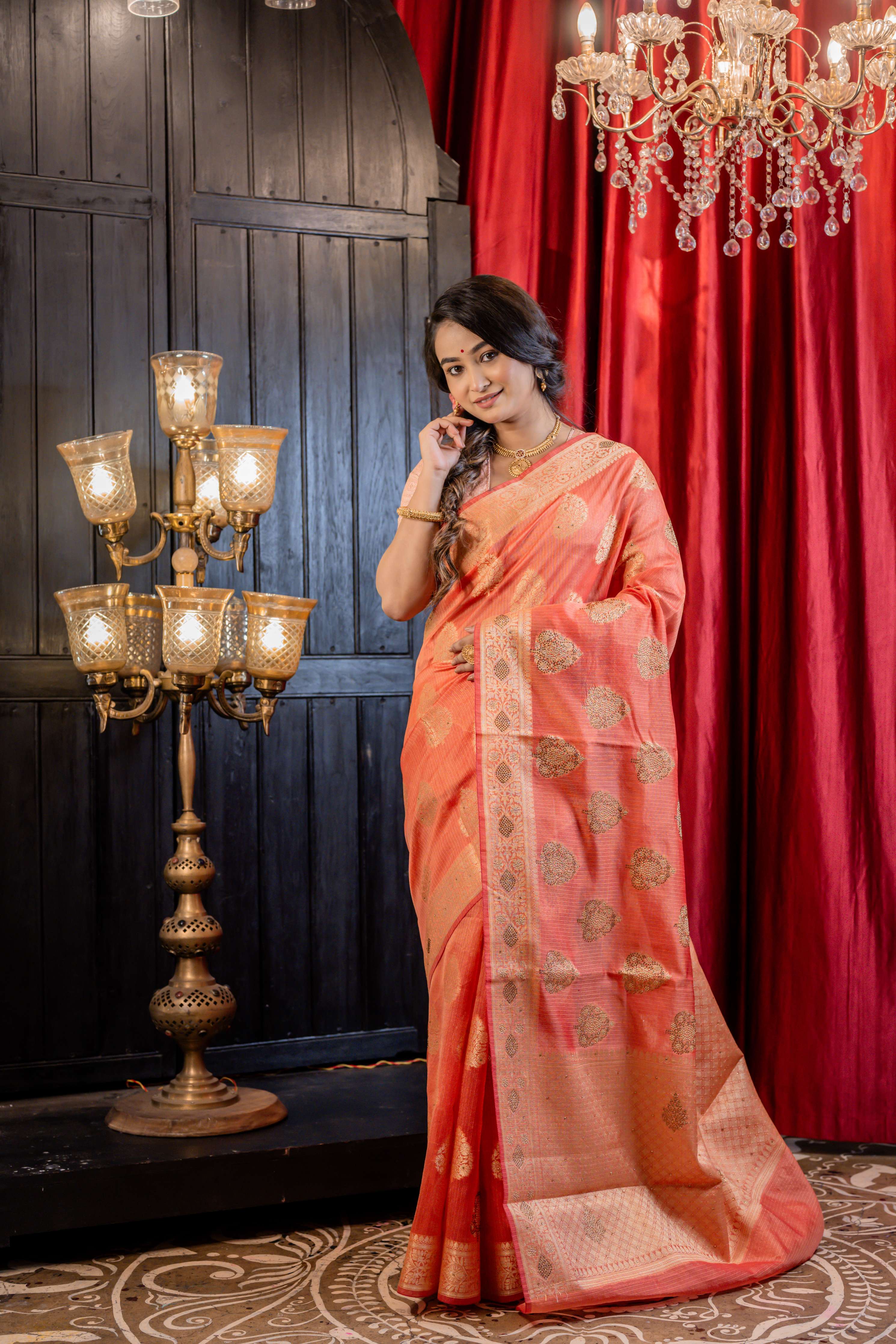 Ruchira || Brick Red Soft Silk Banarasi Saree with all over Matte Gold Zari Floral Buta, Brocade Pallu and Gold Rhinestone bead highlights