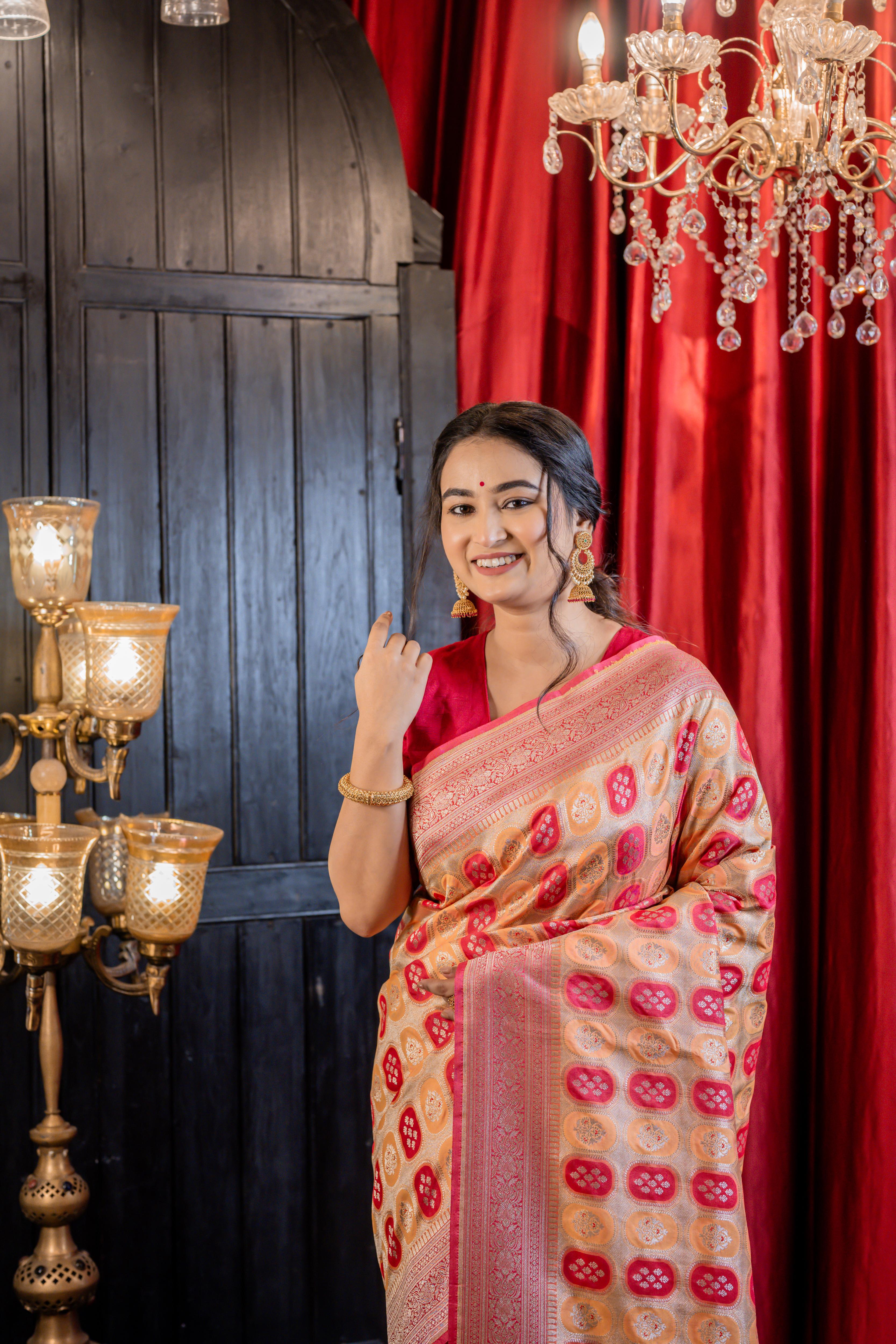 Abha || Woven Matte Gold Zari base Matka Silk Banarasi Saree with all over Peach & Raspberry Red Capsule shape Buta and Meenakari Floral highlights