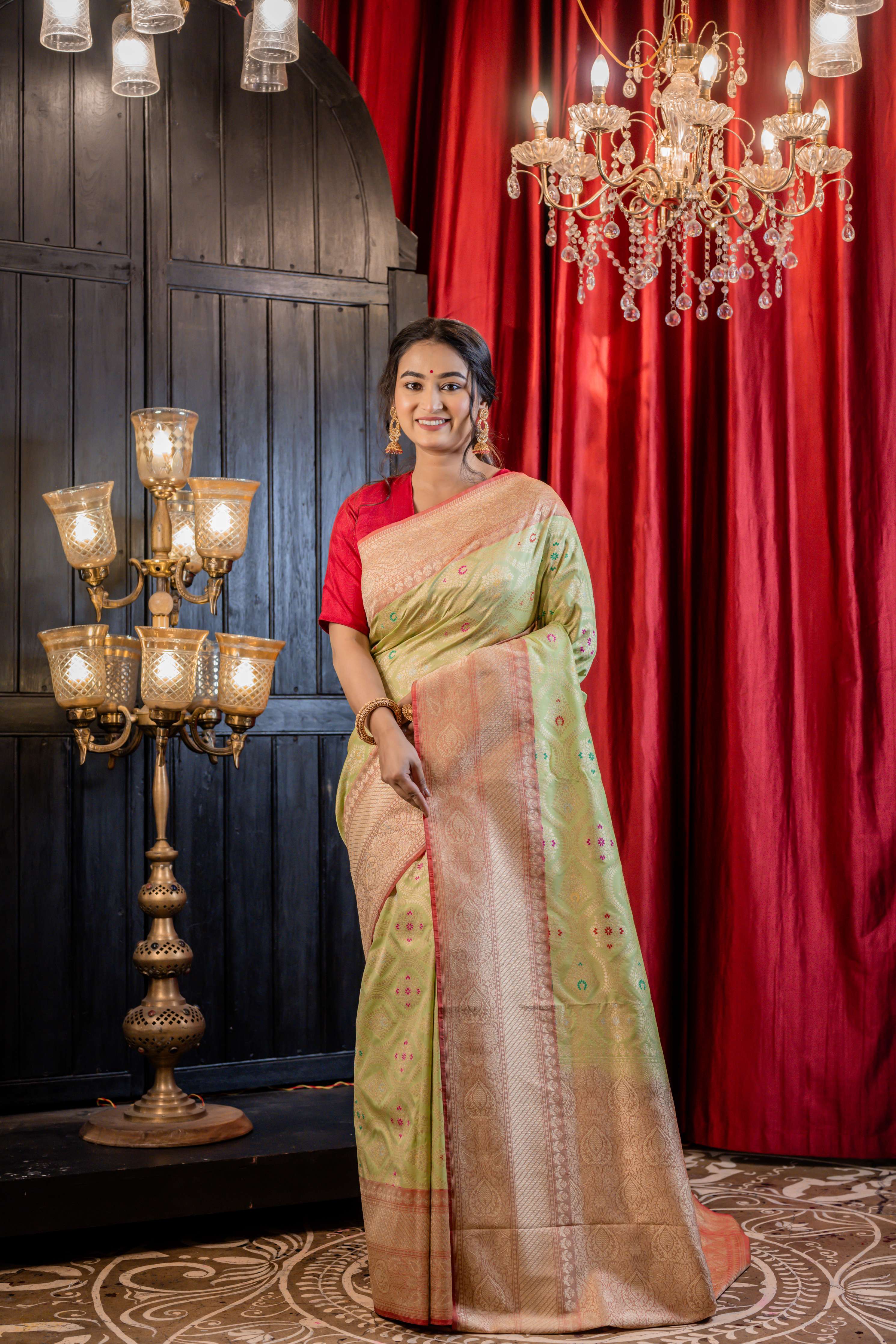 Palashini || Pista Green Matka Silk Banarasi Saree with Multi-colour Meenakari highlights, all over Jaal woven in Matte Gold Zari and Pale Orange border