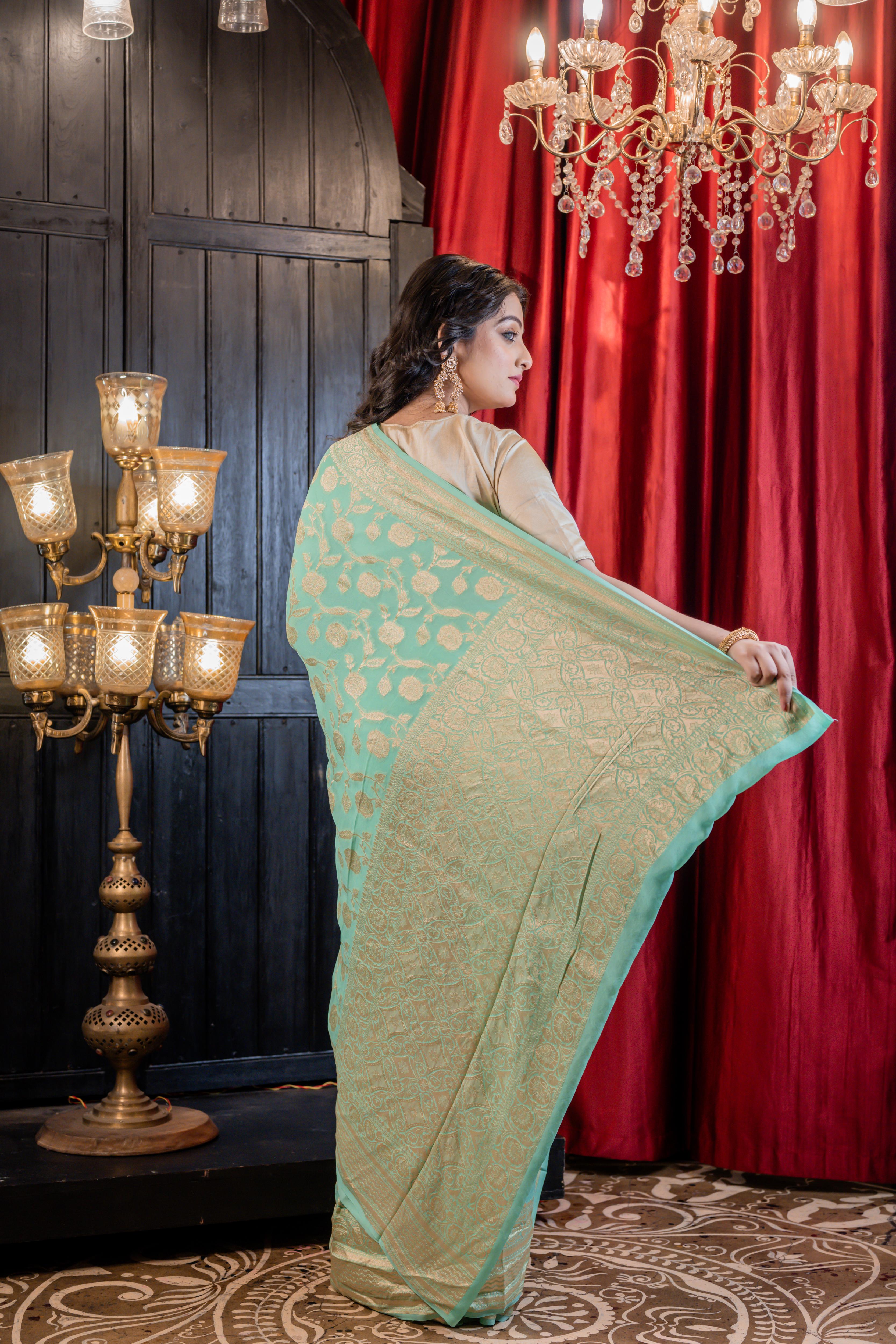 Sagarika || Sea Green Khaddi Georgette Banarasi Saree with all over 'Rose' motif & Jangla in Matte Gold Zari