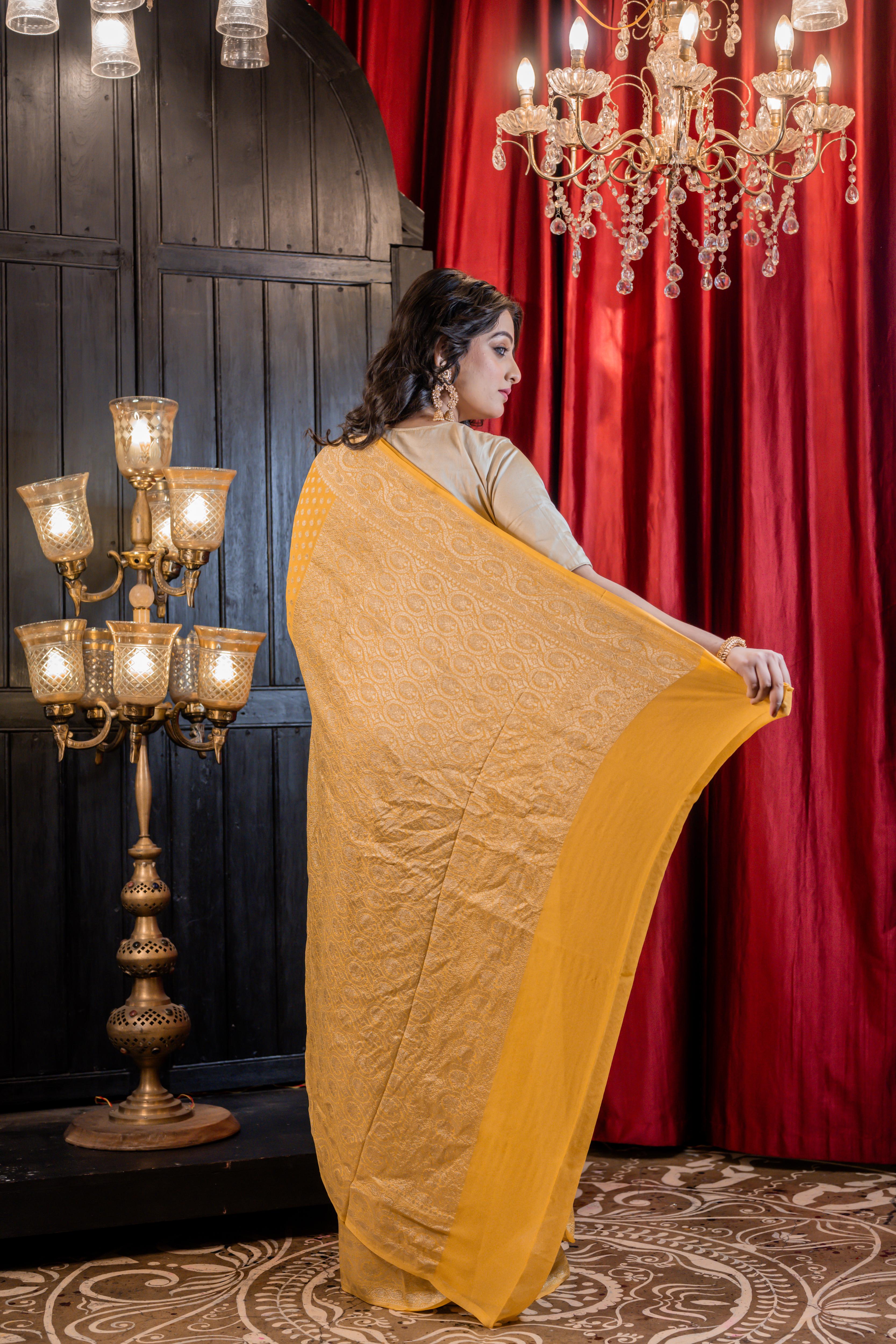 Suravi || Mango Yellow Khaddi Georgette Banarasi Saree with all over Matte Gold Zari Buti