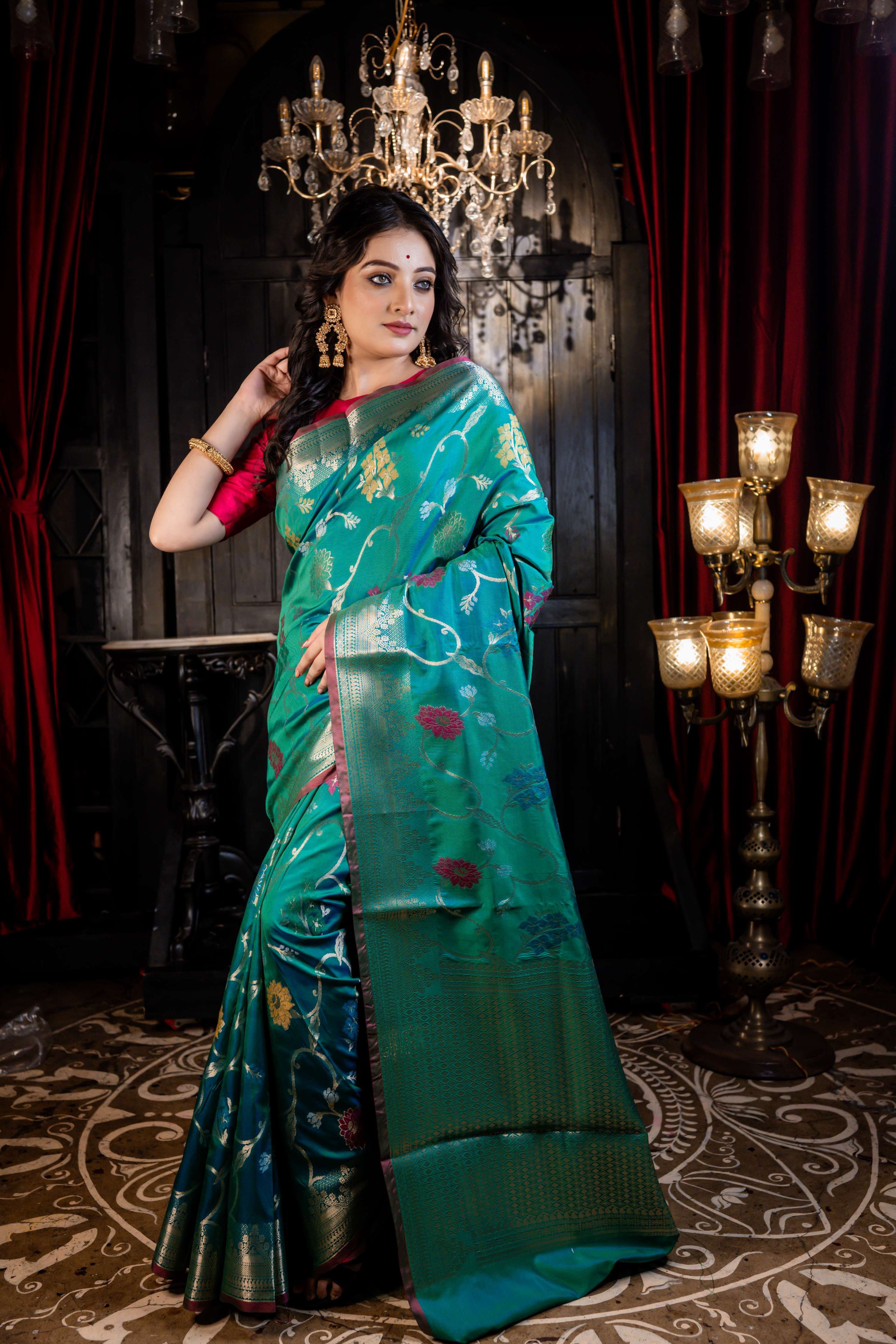 Kalapini || Green & Peacock Blue dual-tone Soft Silk Banarasi Saree with all over multi-colour Resham Floral motif and Jaal in Golden Zari