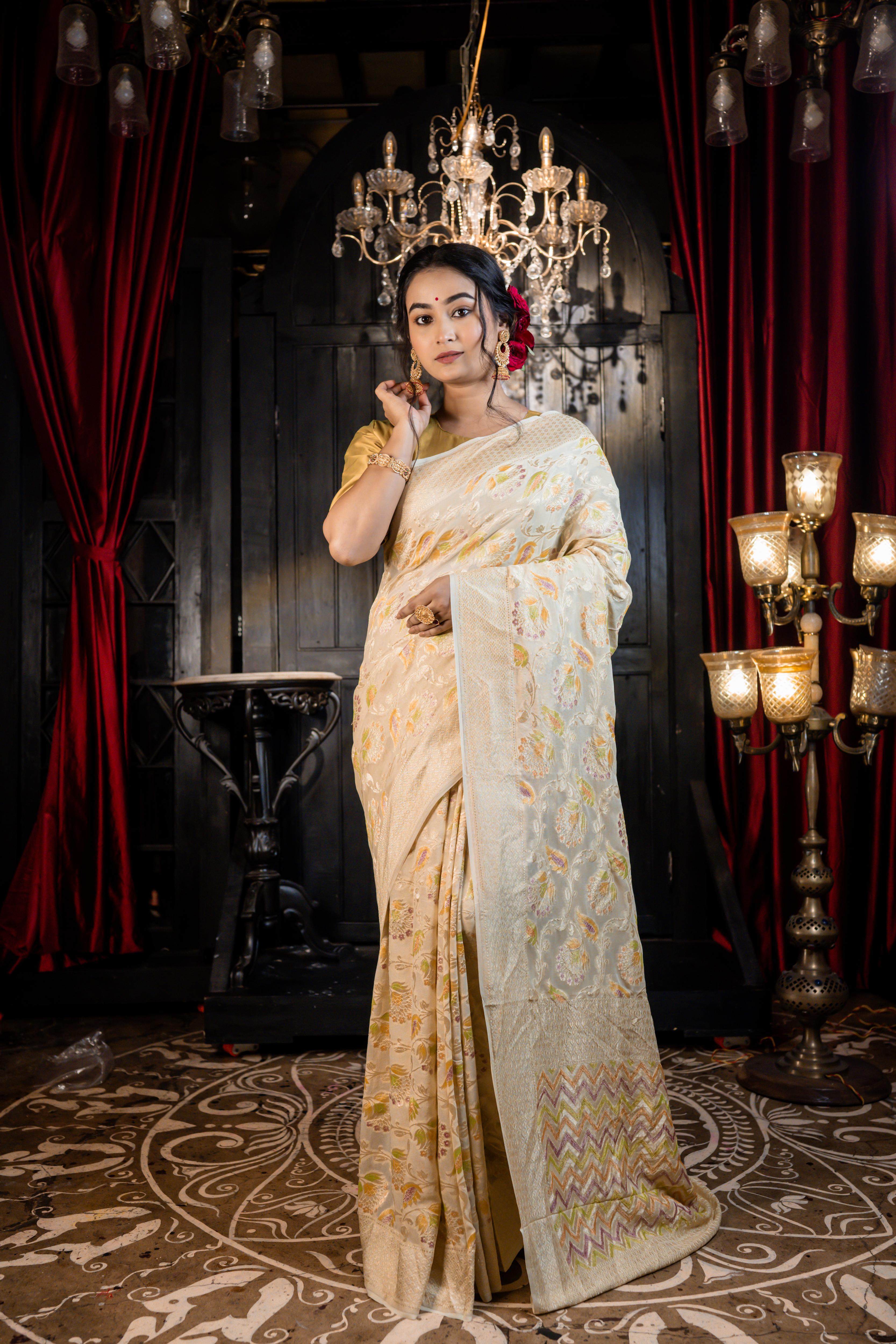 Iva || Ivory Khaddi Georgette Banarasi Saree with all over Rifling Handbrush Multi-colour & Matte Gold Zari Floral motif Jangla