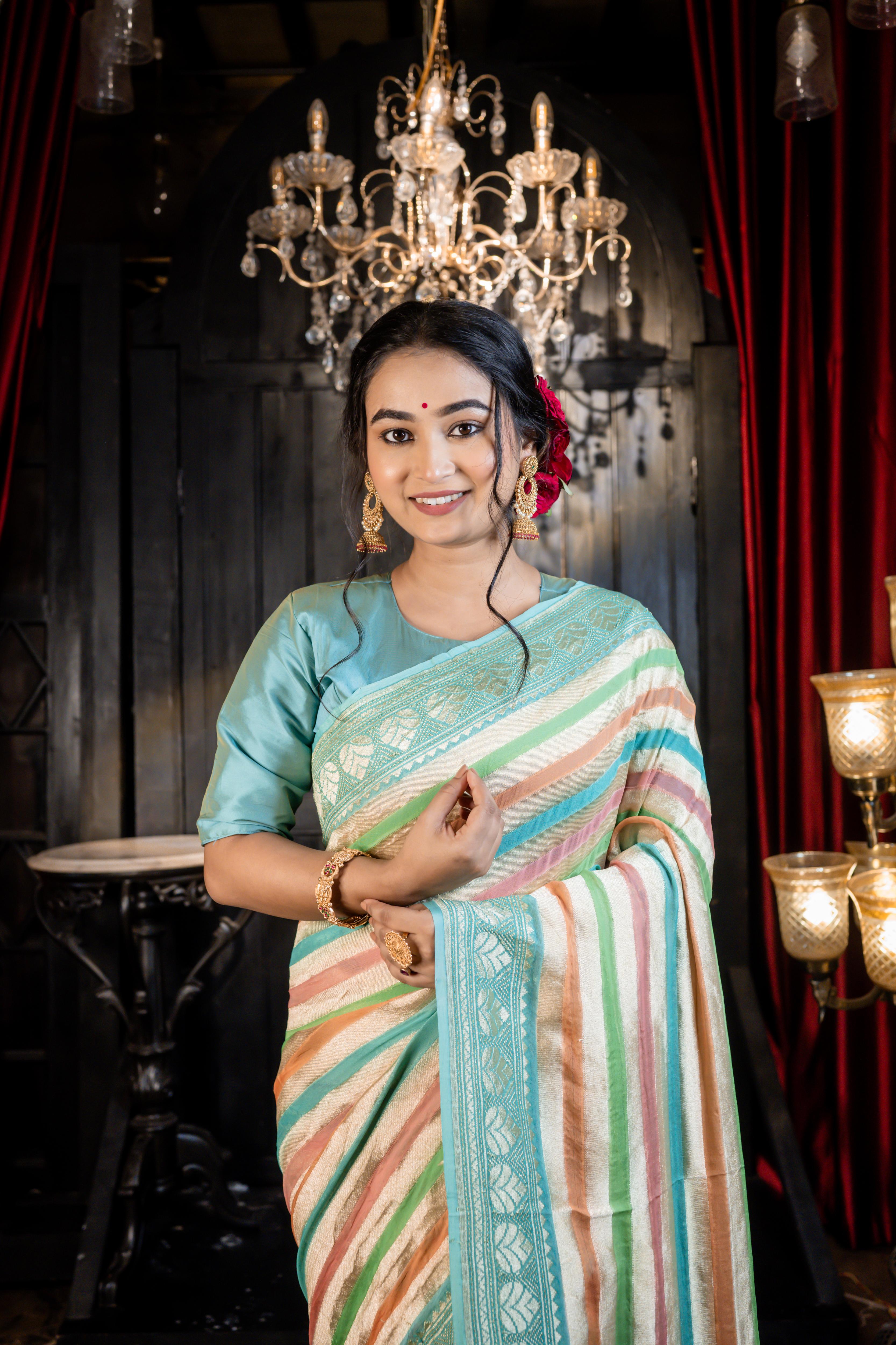 Leheri || All over Rifling Handbrush Multi-coloured & Matte Gold Zari woven Stripes Khaddi Georgette Banarasi Saree with Sky Blue & Matte Gold Zari border