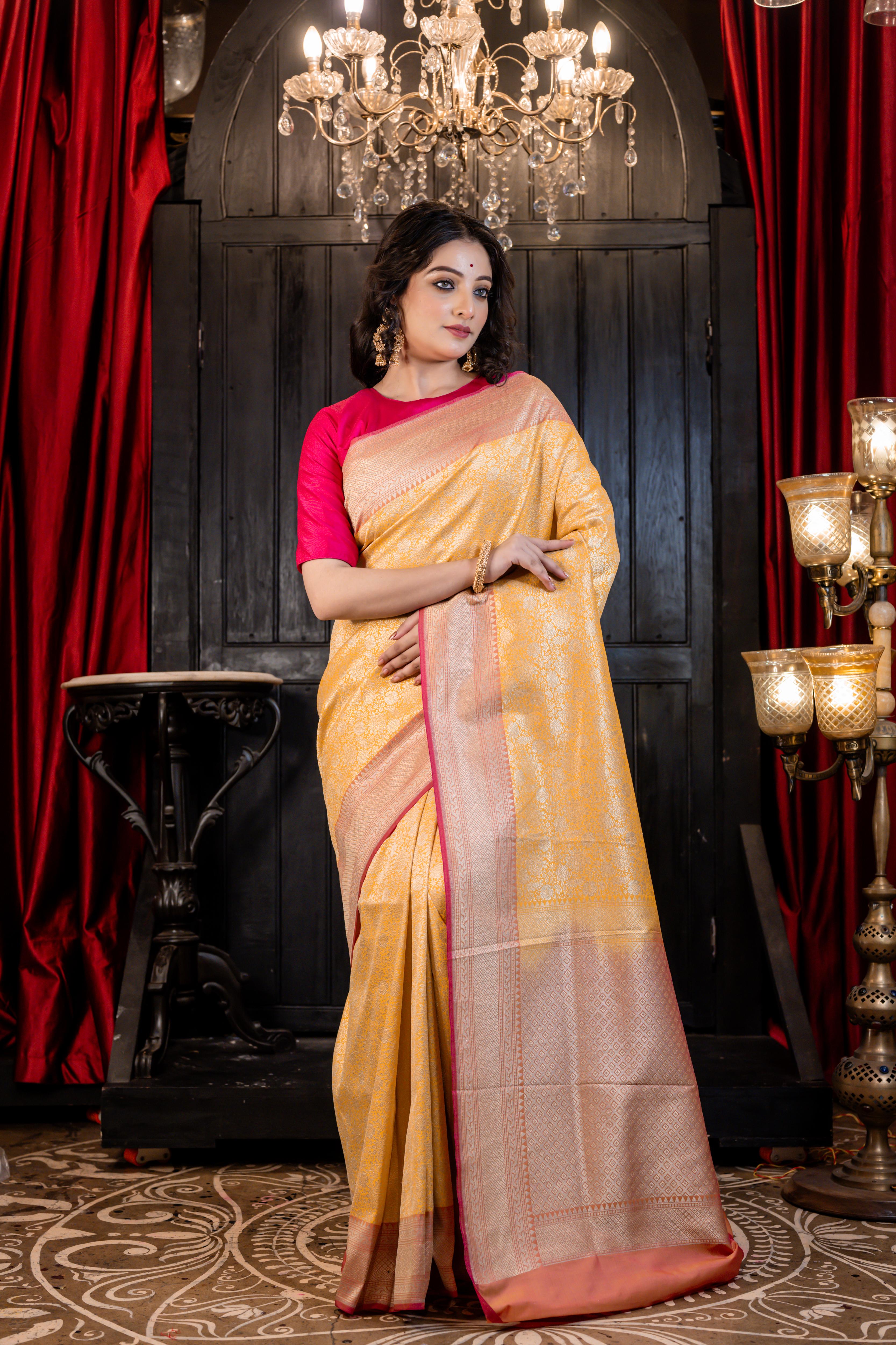 Aruni || Turmeric Yellow Matka Silk Banarasi Saree with all over Floral Jangla woven in Matte Gold Zari and Peach Pallu