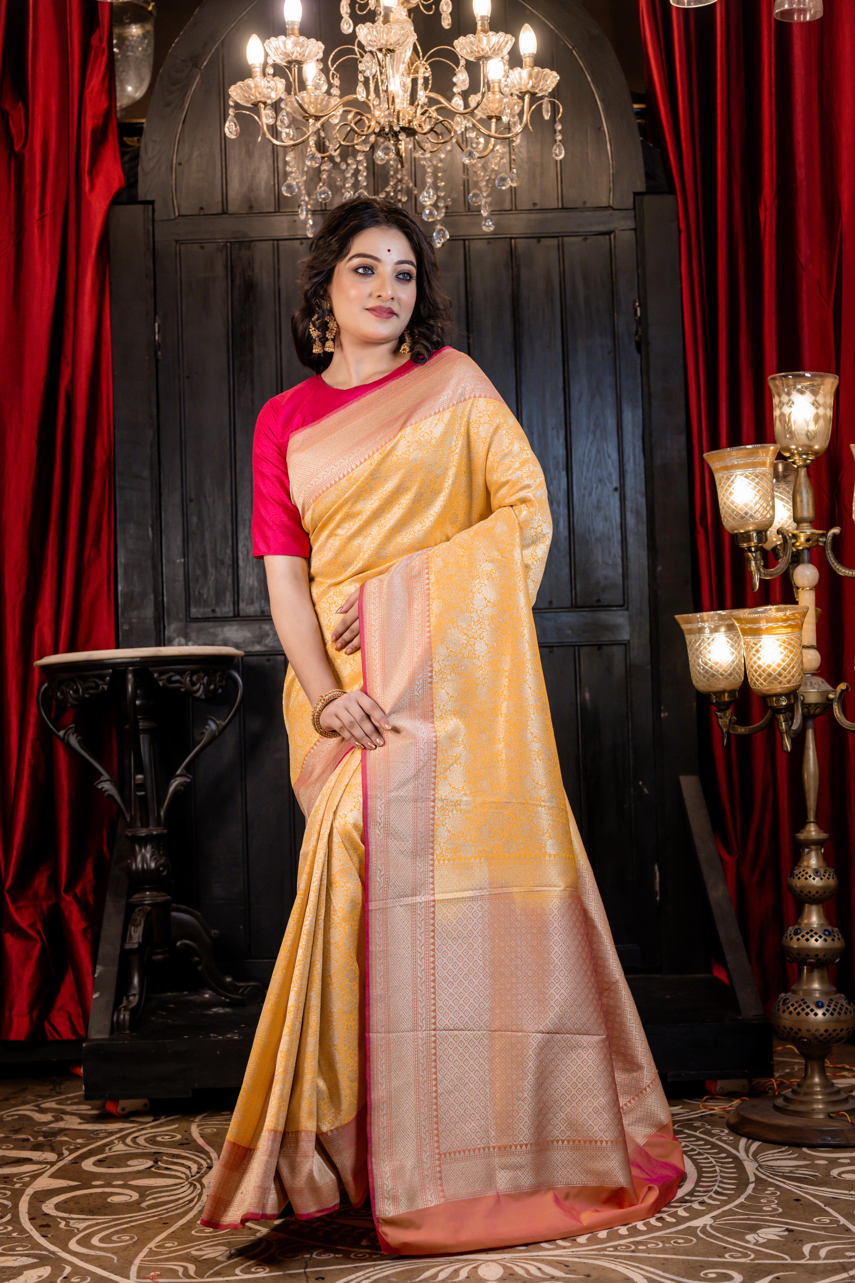 Aruni || Turmeric Yellow Matka Silk Banarasi Saree with all over Floral Jangla woven in Matte Gold Zari and Peach Pallu