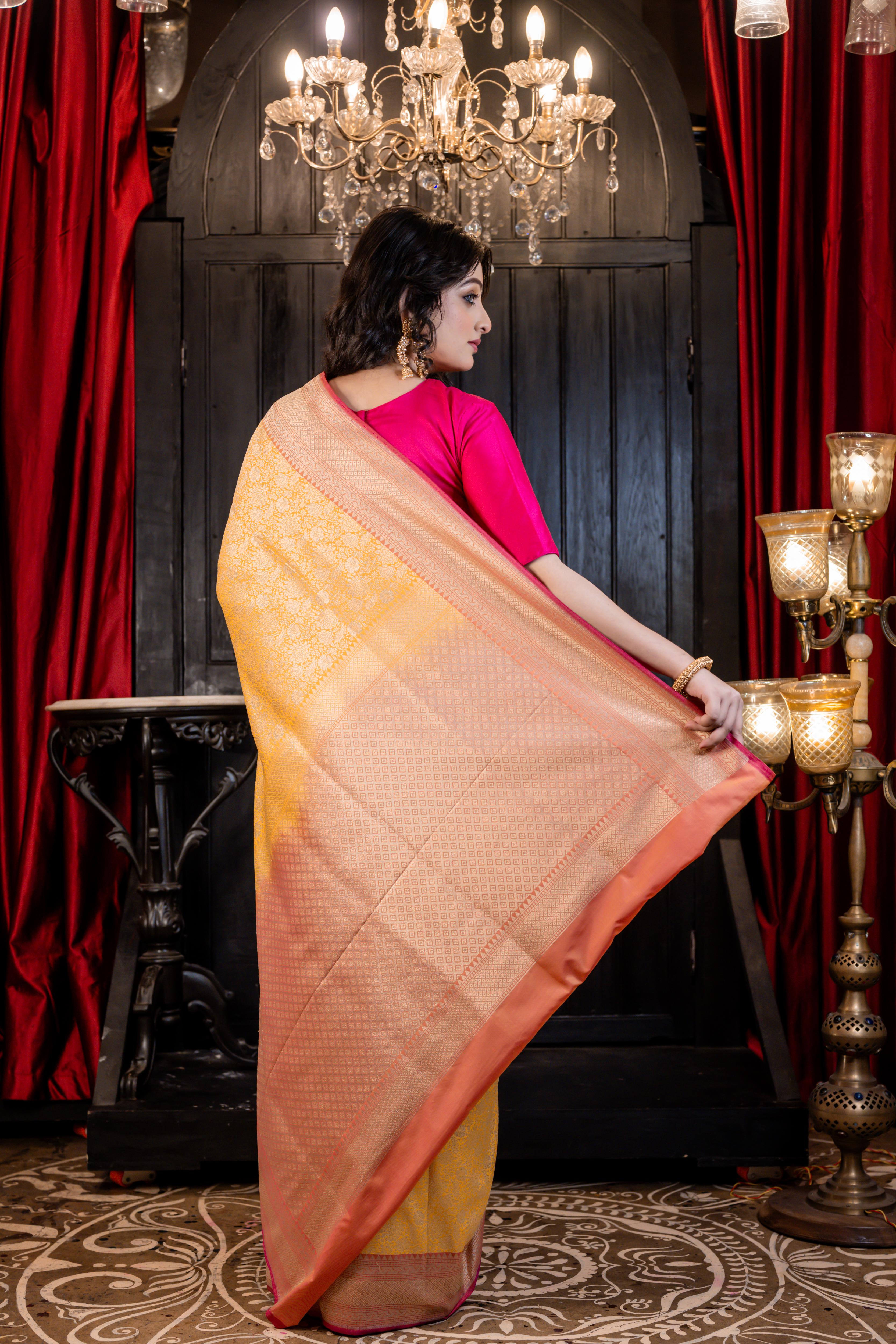 Aruni || Turmeric Yellow Matka Silk Banarasi Saree with all over Floral Jangla woven in Matte Gold Zari and Peach Pallu