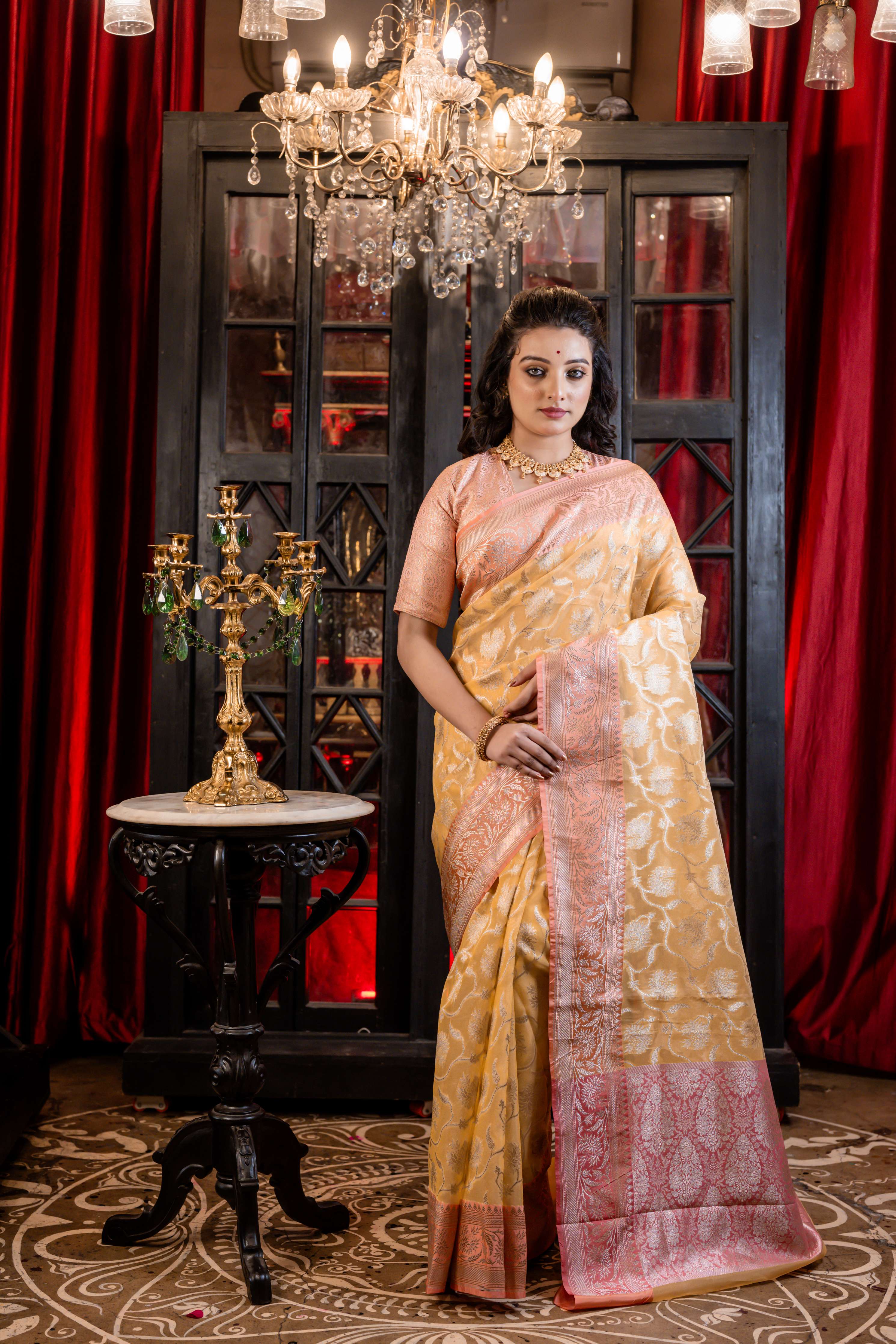 Hyma || Mango Yellow Organza Banarasi Saree with all over Matte Gold Zari Floral Jaal and Coral Pink Border