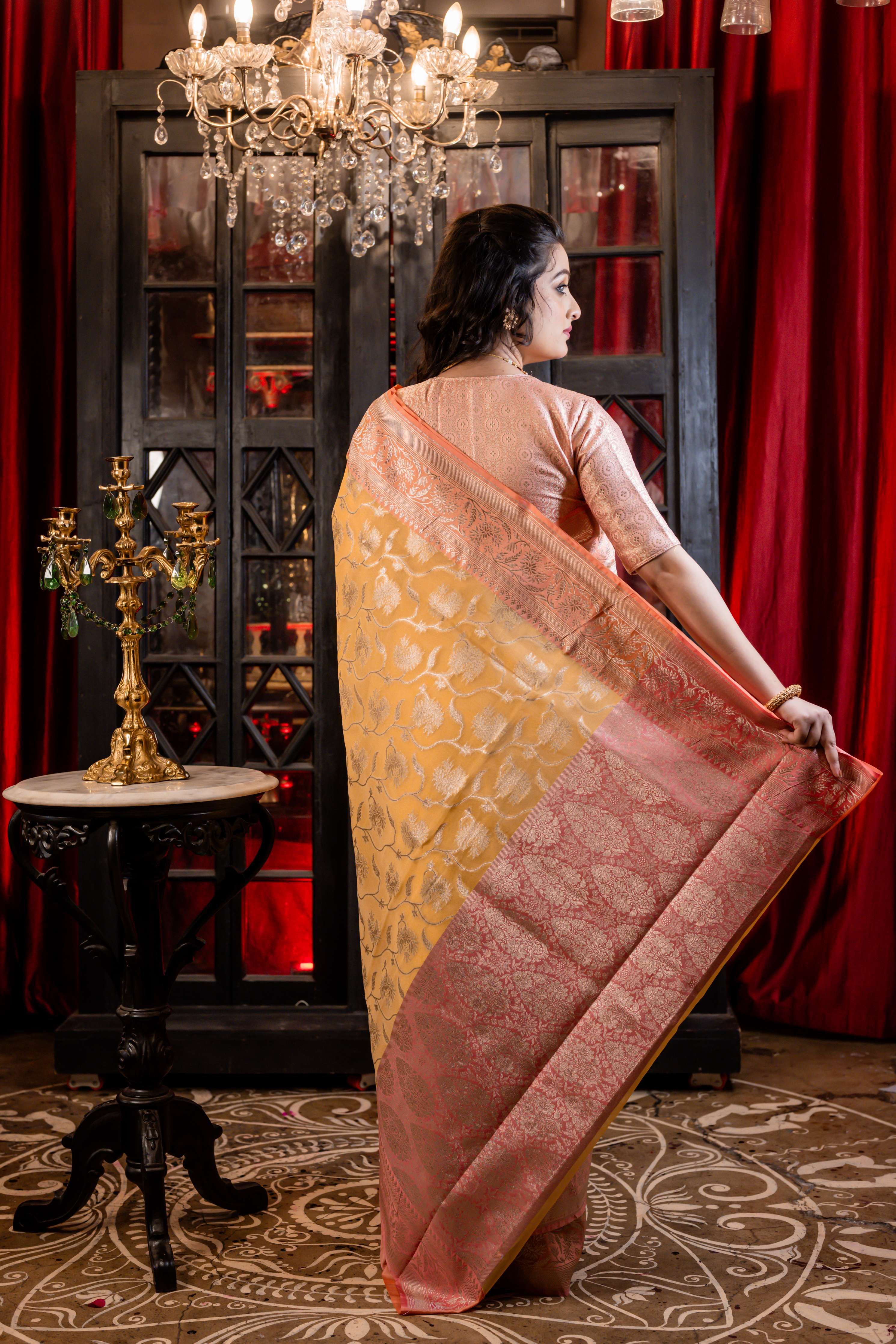 Hyma || Mango Yellow Organza Banarasi Saree with all over Matte Gold Zari Floral Jaal and Coral Pink Border