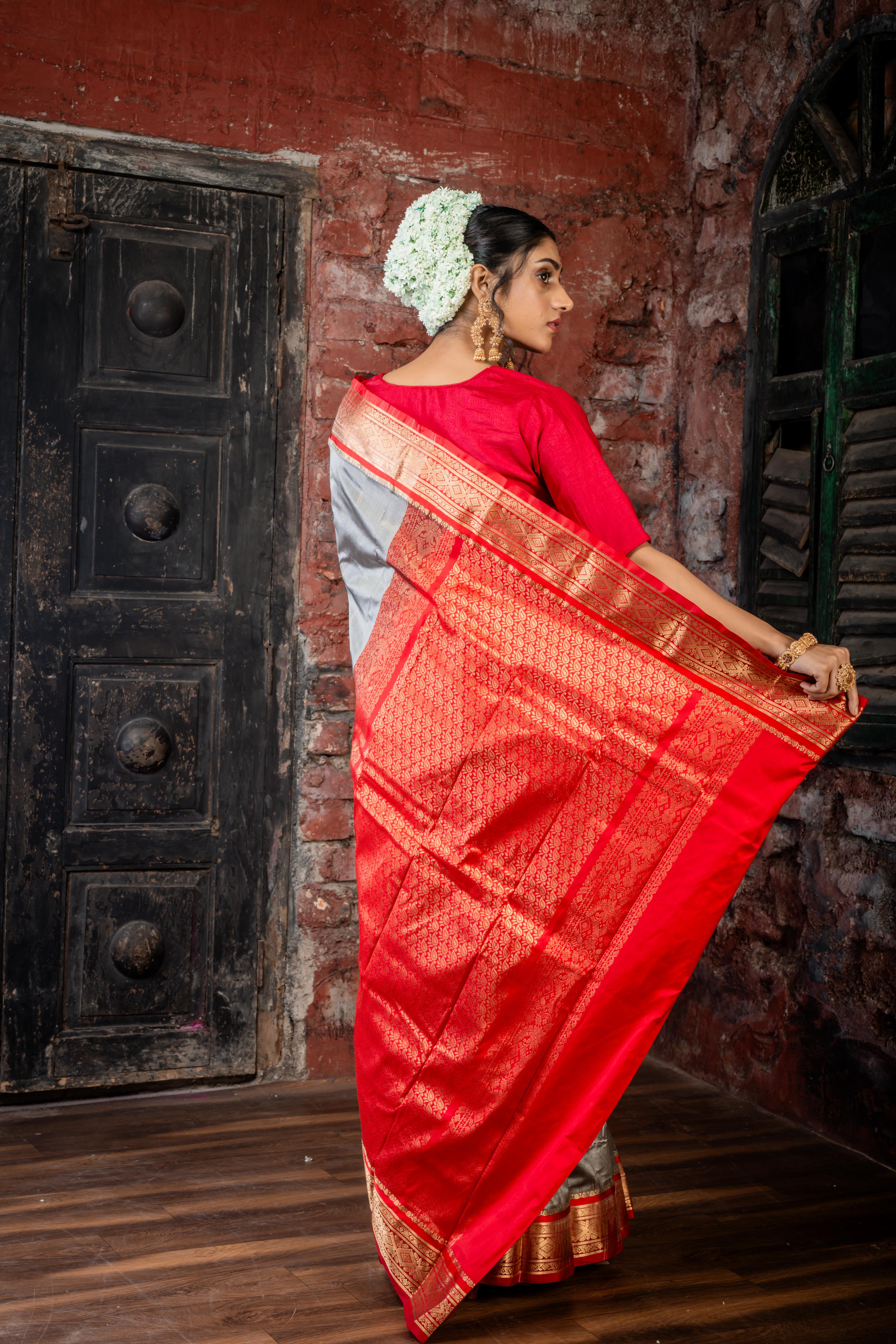 Amala || Smokey Grey Kanjivaram Silk Saree with all over Matte Gold Zari Buti, Red & Matte Gold Zari Border and Red Pallu in Matte Gold Zari Traditional 'Kalka' design