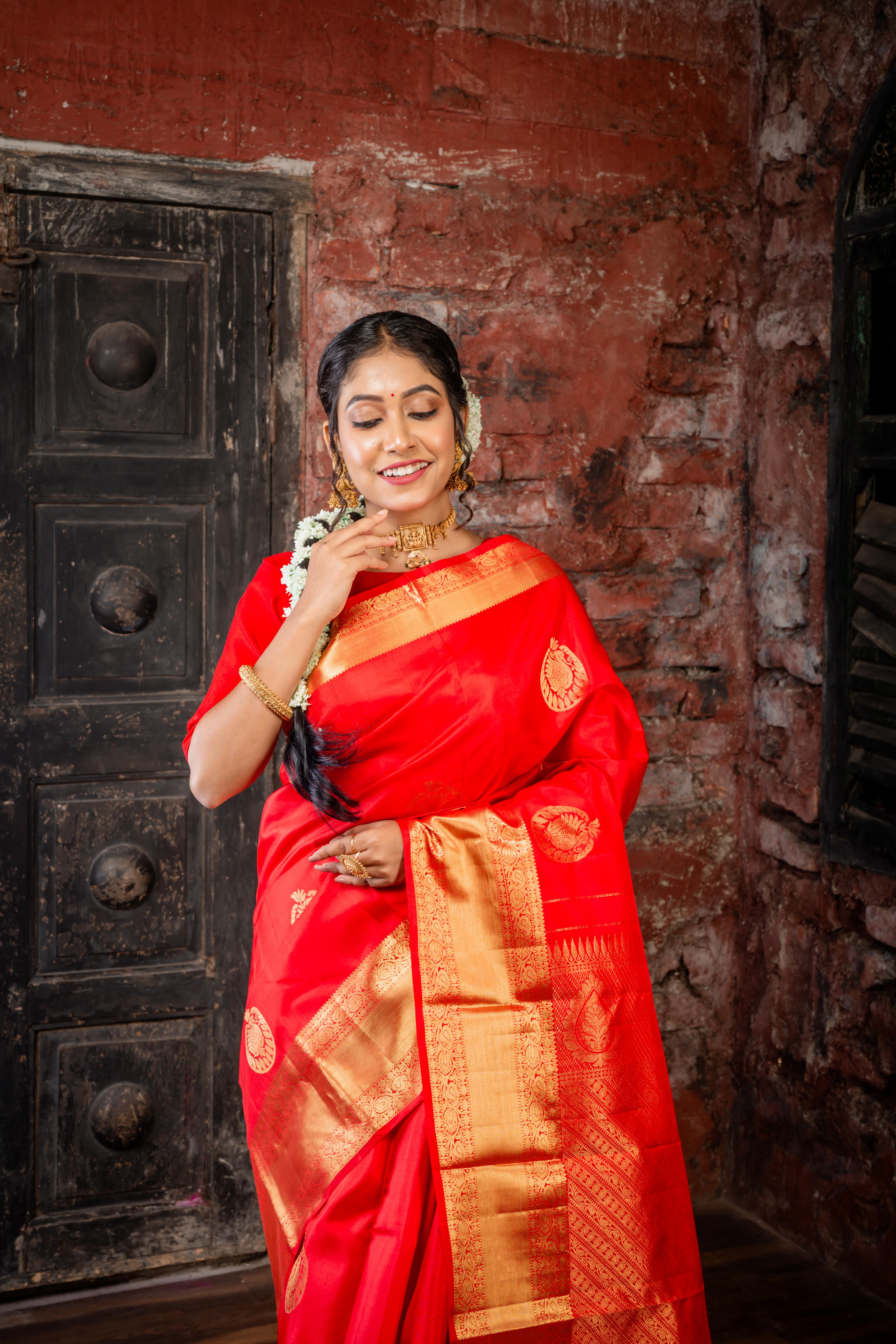 Navya || Bright Red Pure Silk Handloom Saree with all over Abharani Gold Zari Lotus & Swan motif Buta and traditional Stripe Pallu