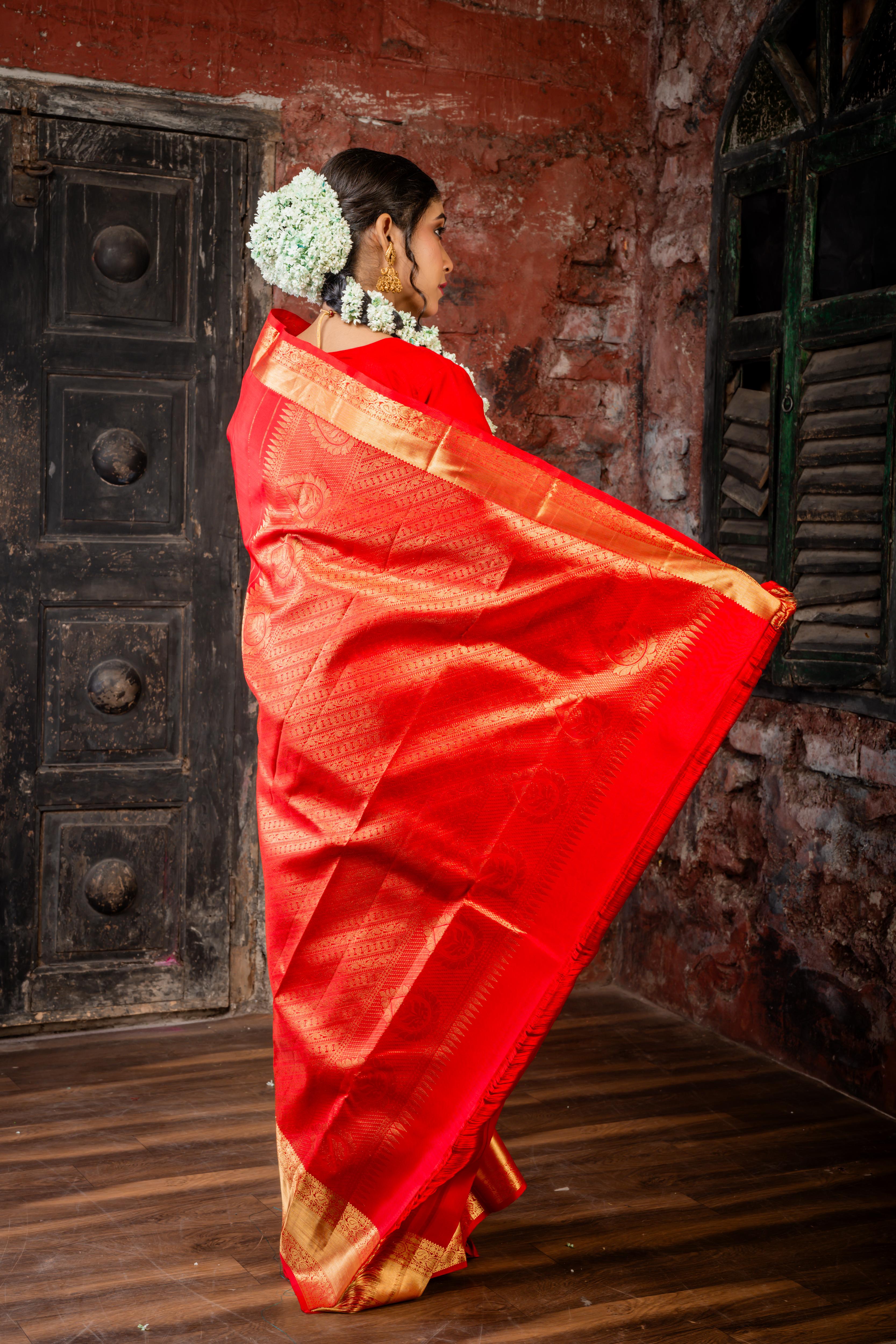 Navya || Bright Red Pure Silk Handloom Saree with all over Abharani Gold Zari Lotus & Swan motif Buta and traditional Stripe Pallu