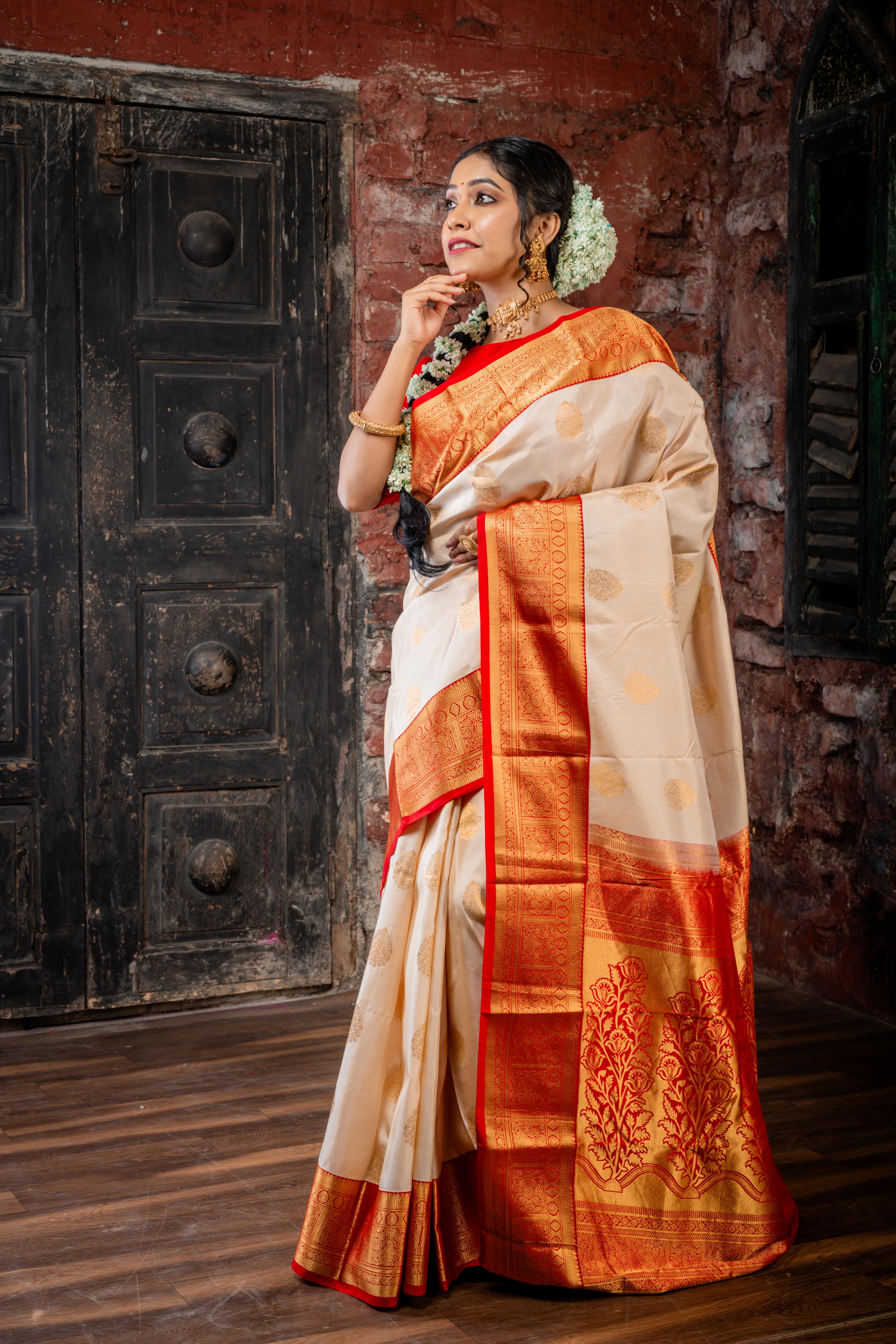 Chinmayi || Ivory Gold Pure Kanjivaram Silk Handloom Saree with all over Golden Zari traditional Buta, Red broad & Golden Zari Border and traditional Floral motif Pallu