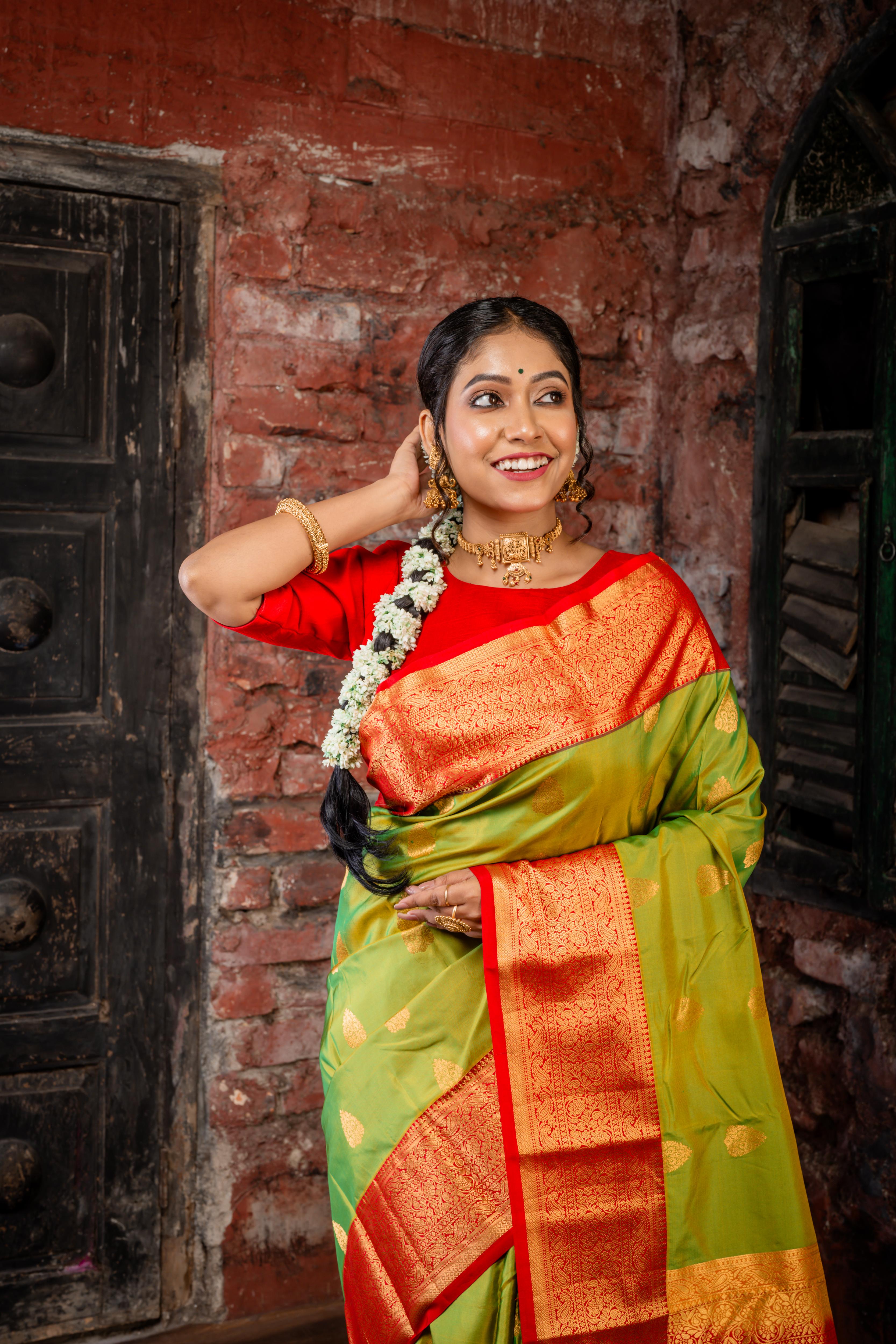 Laajvanthi || Olive Green & Mustard Yellow dual tone Pure Kanjivaram Silk Handloom Saree with all over Golden Zari traditional Buta, Red broad & Golden Zari Border and traditional design Pallu