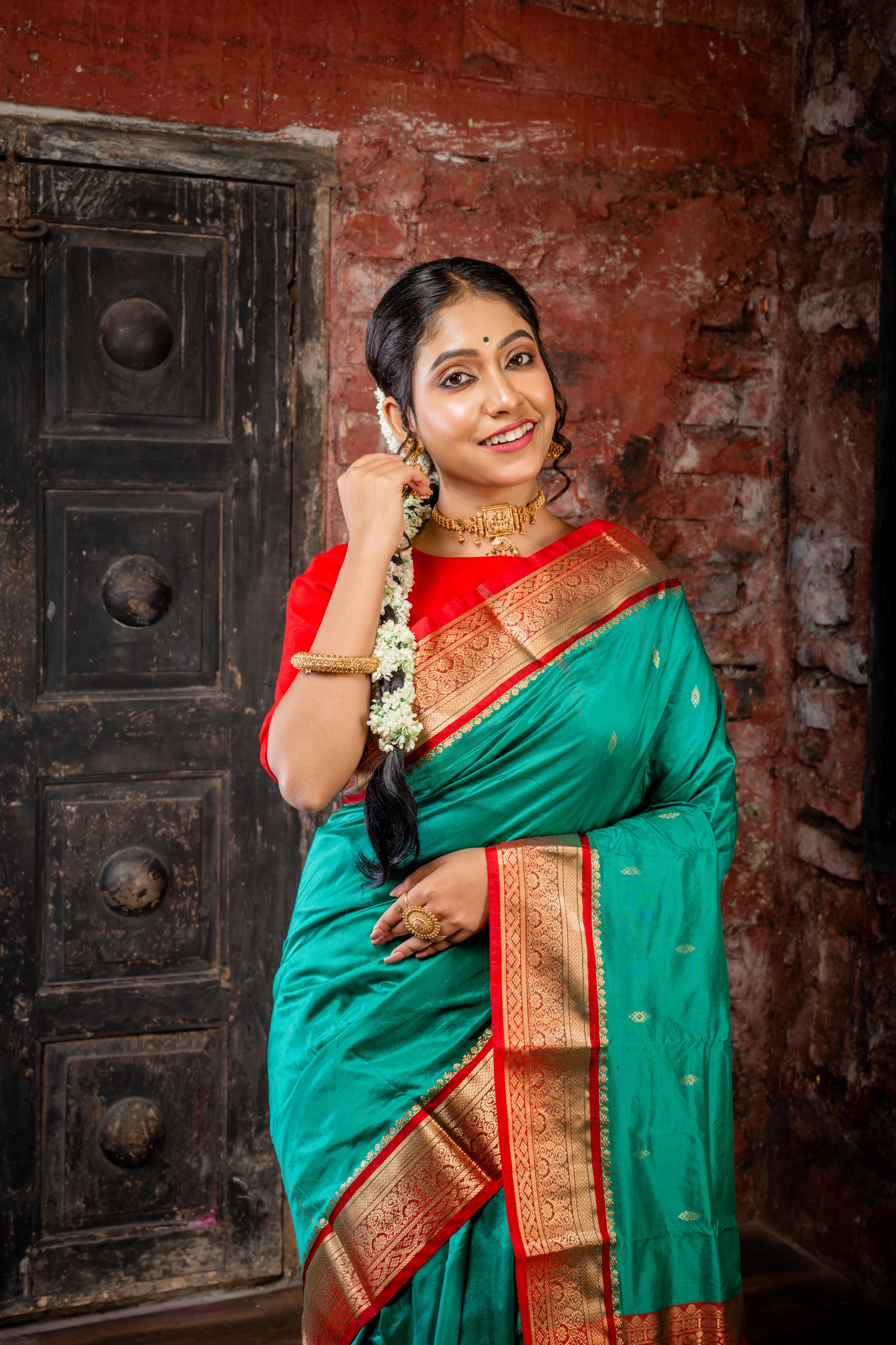 Vamika || Emerald Green Kanjivaram Silk Saree with all over Matte Gold Zari Buta and Dark Red & Matte Gold Zari Traditional design Border & Pallu