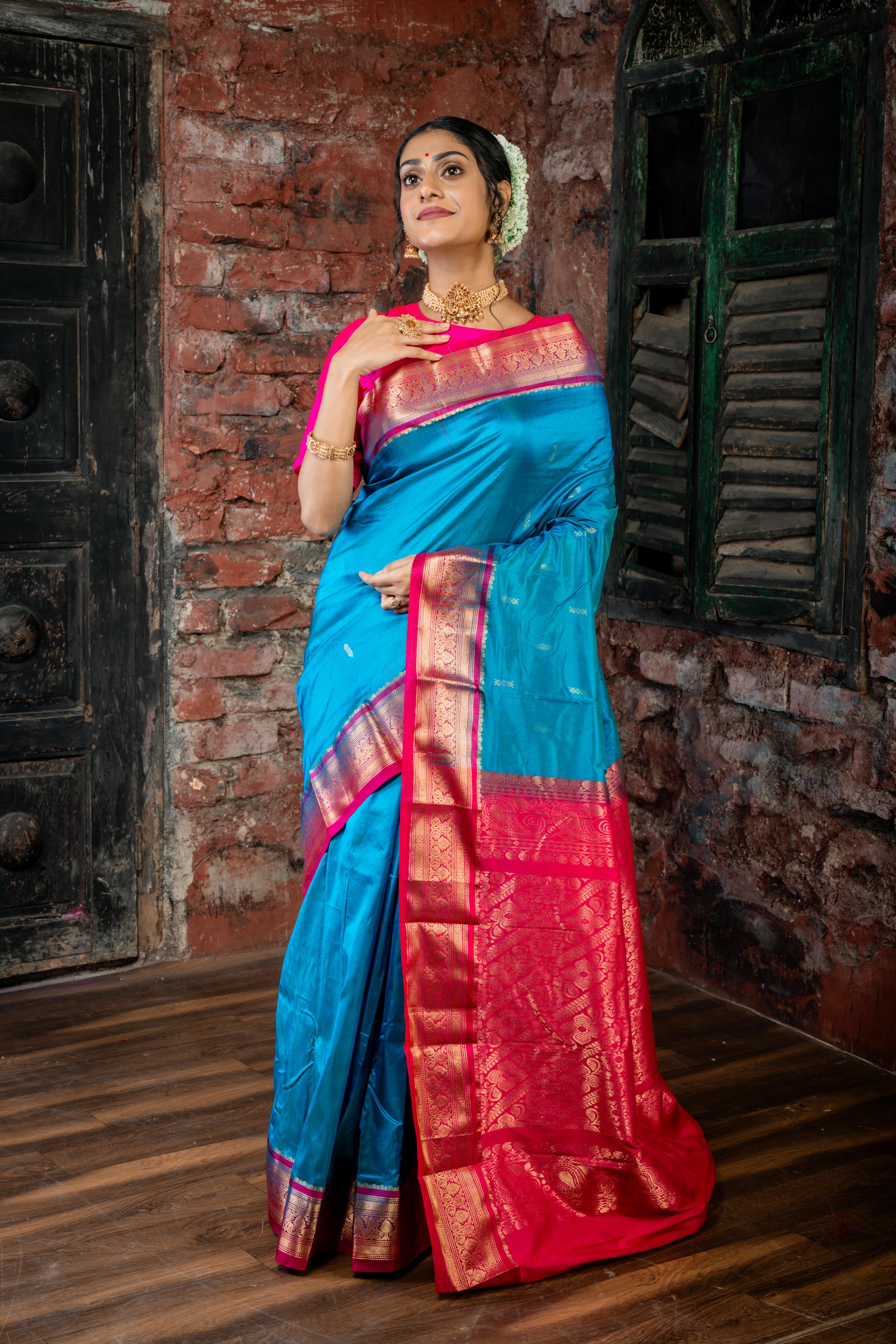 Neelavati || Bright Cyan Blue Kanjivaram Silk Saree with all over Matte Gold Zari Buta, Magenta & Matte Gold Zari Border and Magenta Pallu in Matte Gold Zari Traditional 'Kalka' & Floral design
