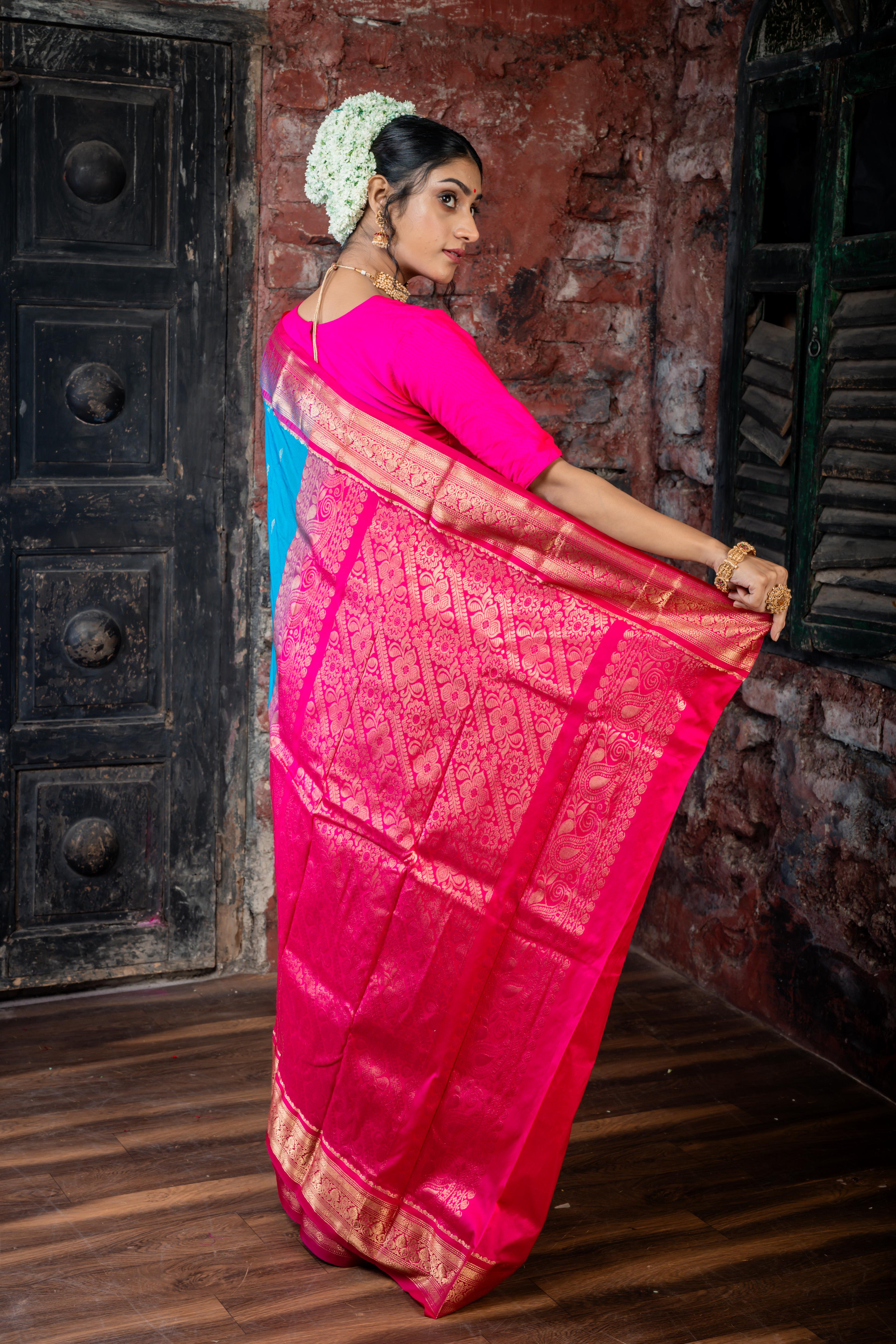 Neelavati || Bright Cyan Blue Kanjivaram Silk Saree with all over Matte Gold Zari Buta, Magenta & Matte Gold Zari Border and Magenta Pallu in Matte Gold Zari Traditional 'Kalka' & Floral design