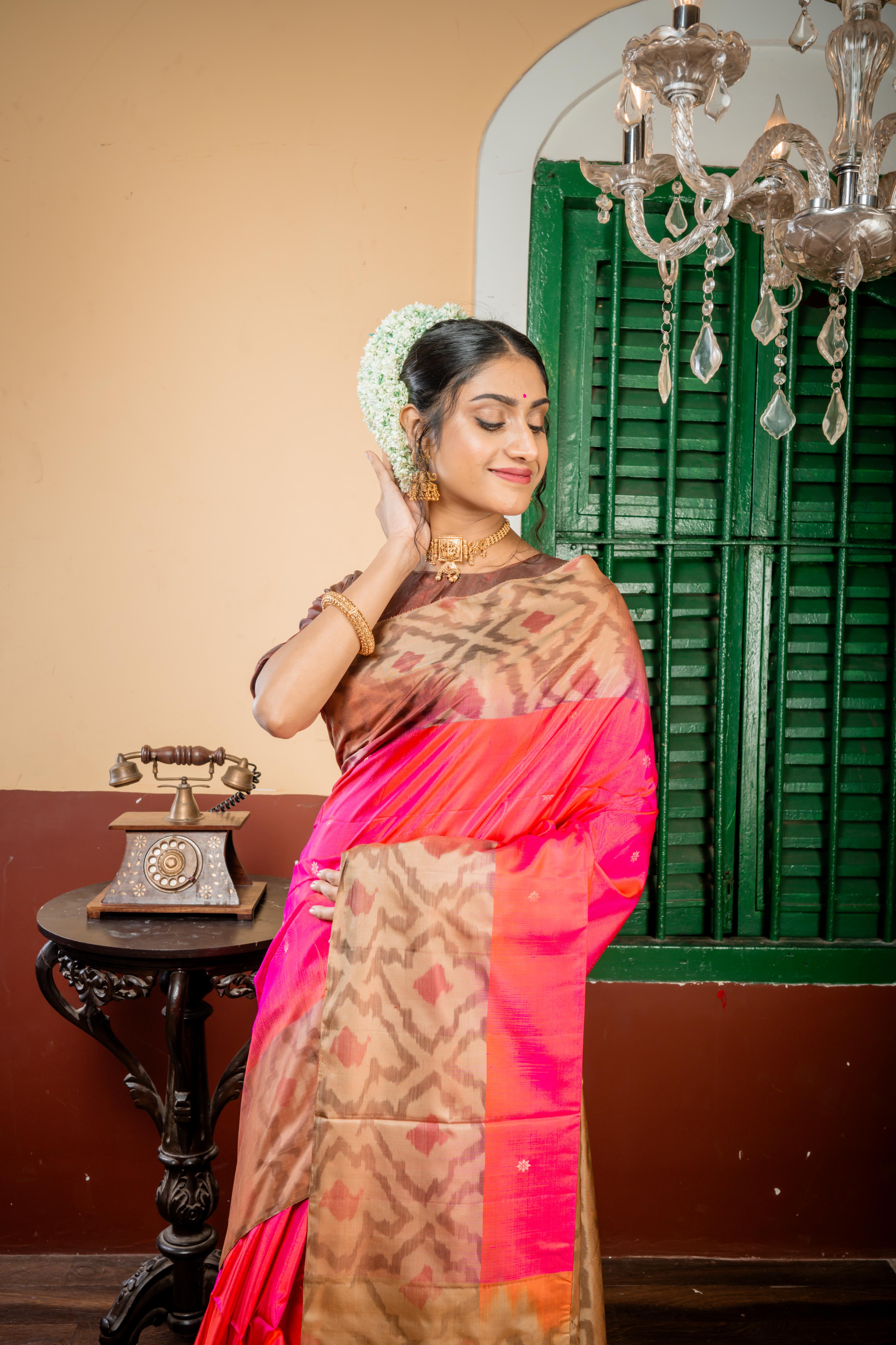 Udisha || Magenta & Rust Orange dual tone Pattu Soft Silk Handloom Saree with all over Copper Zari Buti & Buta and Peanut Brown & Antique Gold dual tone Abstract Border & Pallu