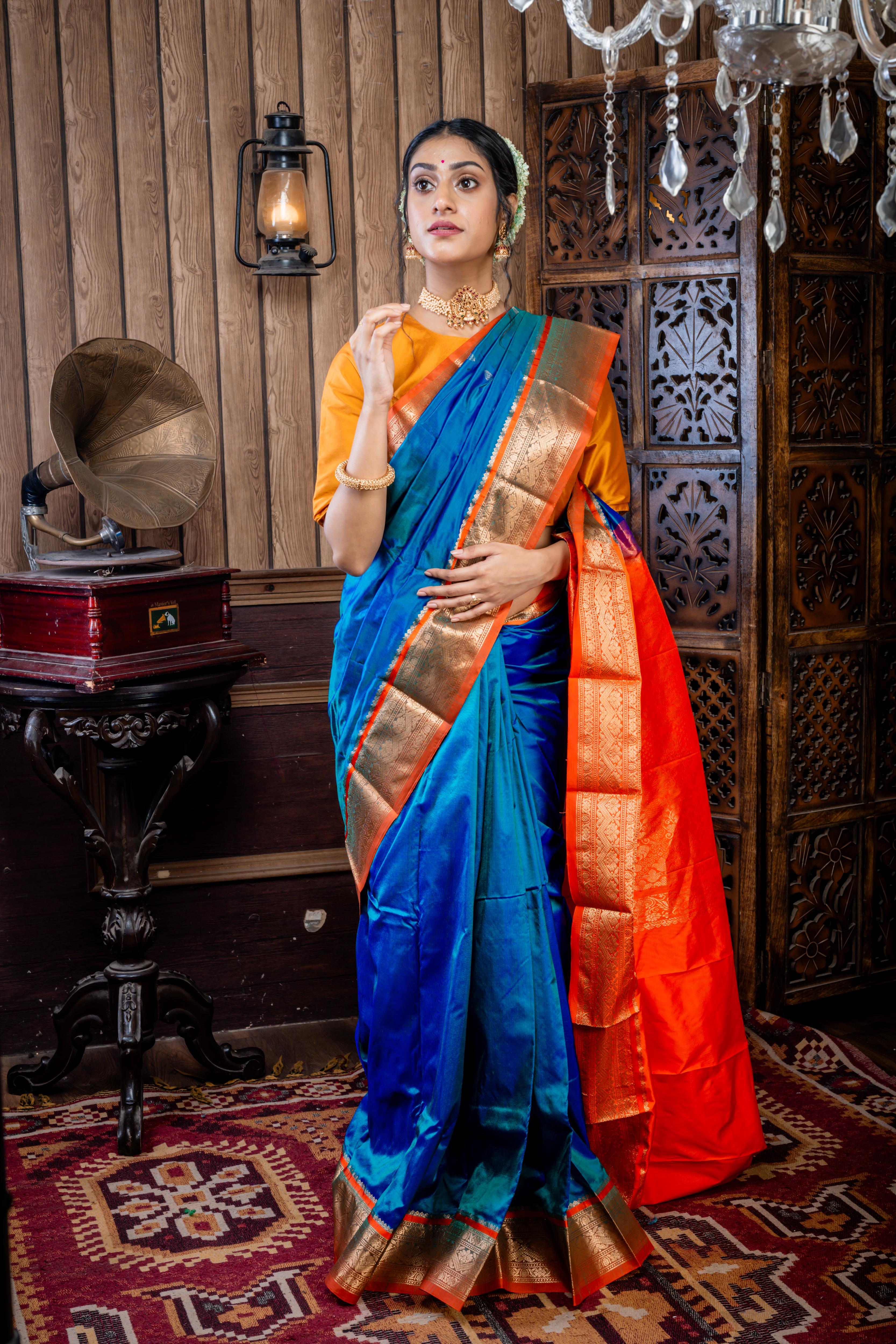Kruttika || Peacock Blue & Green dual tone Kanjivaram Silk Saree with all over Matte Gold Zari Buta and Burnt Orange & Matte Gold Zari Traditional design Border & Pallu