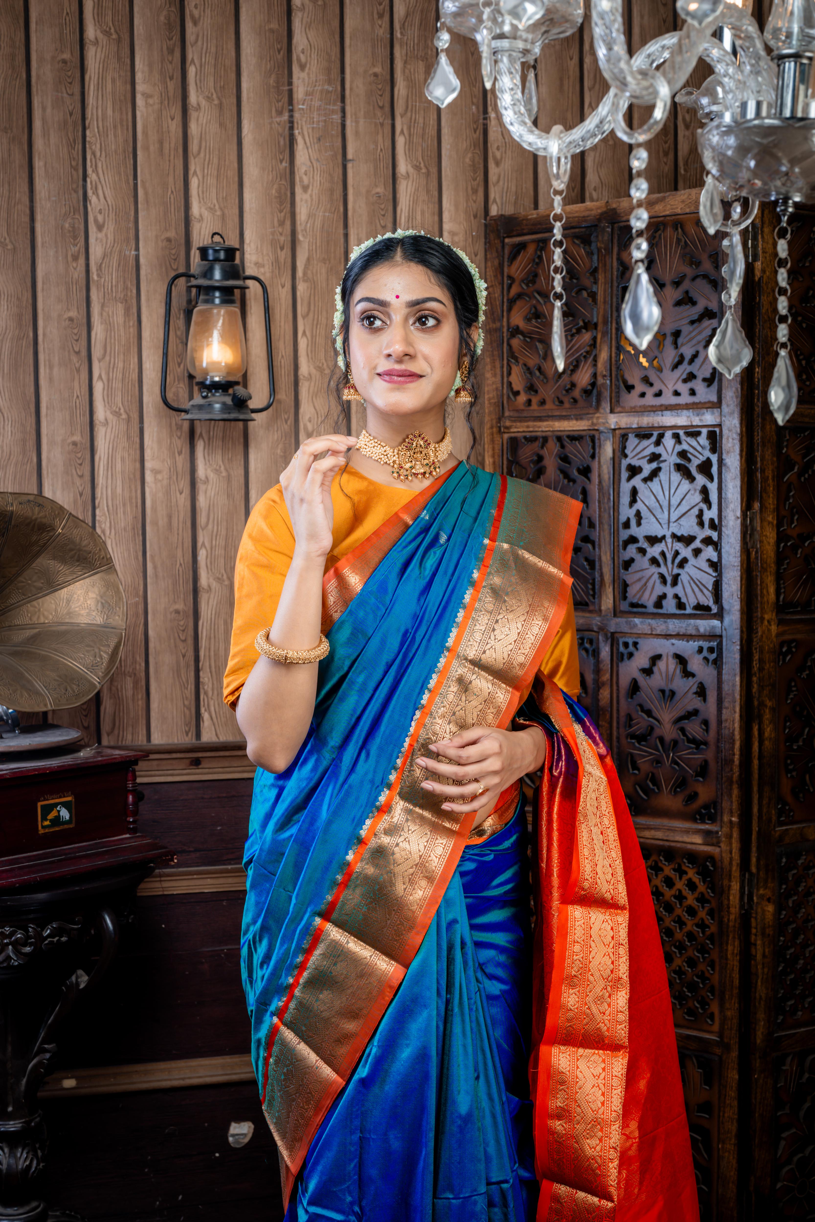 Kruttika || Peacock Blue & Green dual tone Kanjivaram Silk Saree with all over Matte Gold Zari Buta and Burnt Orange & Matte Gold Zari Traditional design Border & Pallu