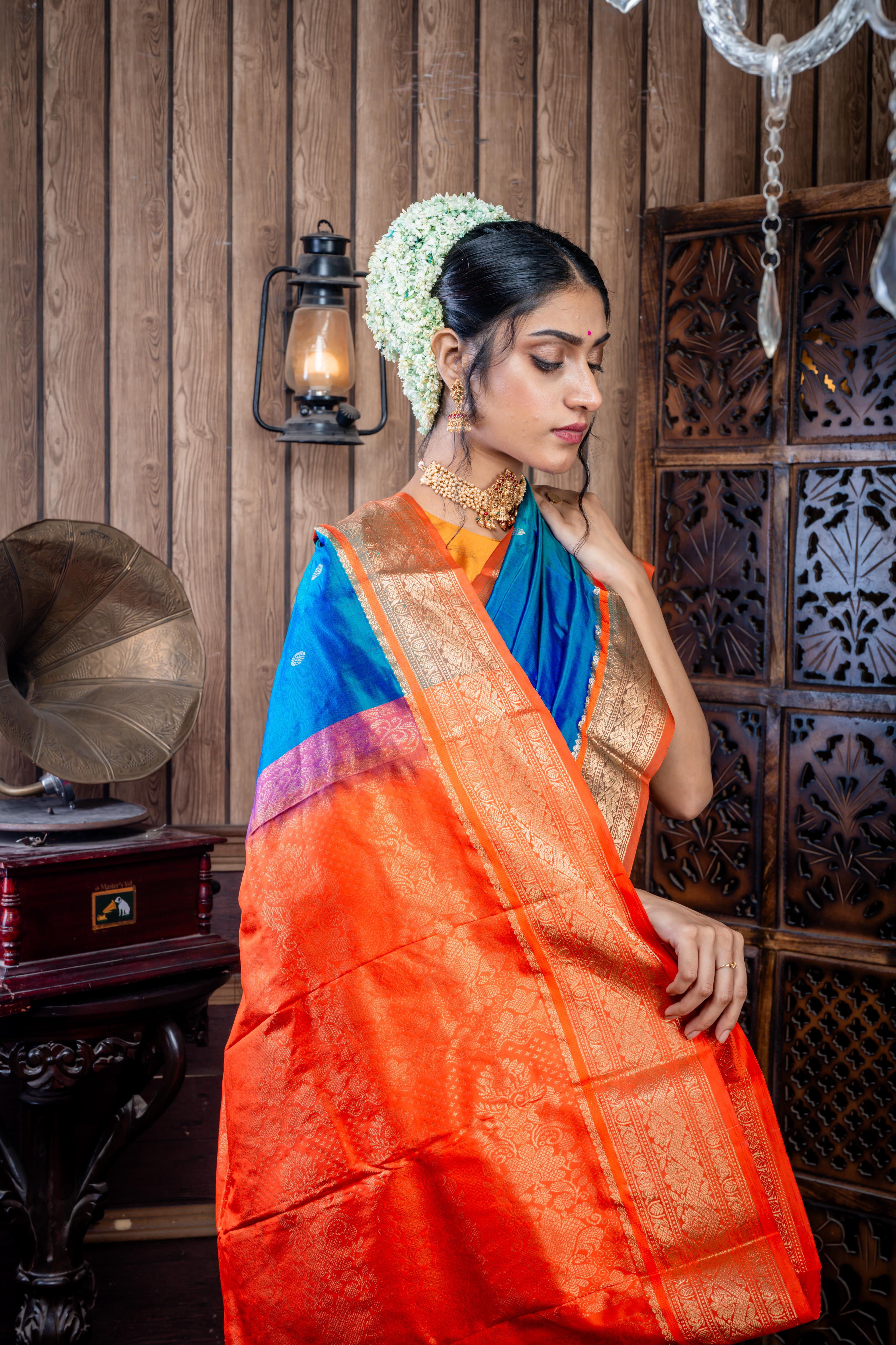 Kruttika || Peacock Blue & Green dual tone Kanjivaram Silk Saree with all over Matte Gold Zari Buta and Burnt Orange & Matte Gold Zari Traditional design Border & Pallu