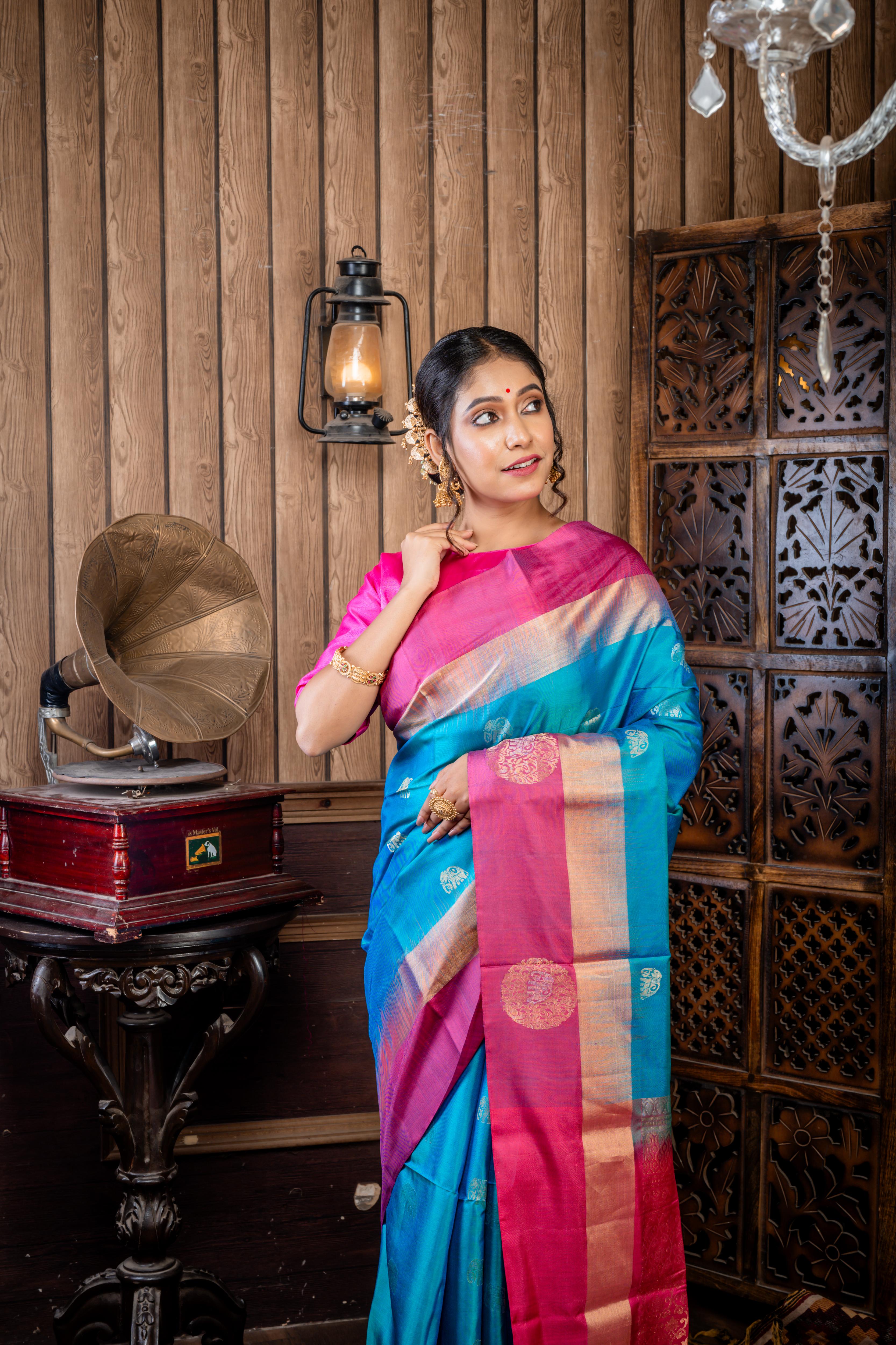 Iravathi || Turquoise Blue & Green dual tone Pattu Soft Silk Handloom Saree with all over Antique Gold & Silver Zari 'Elephant' motif Buta, Light Ruby Pink with 'Sona Rupa' Zari 'Elephant' motif & Antique Gold Zari Plain Border and Pallu