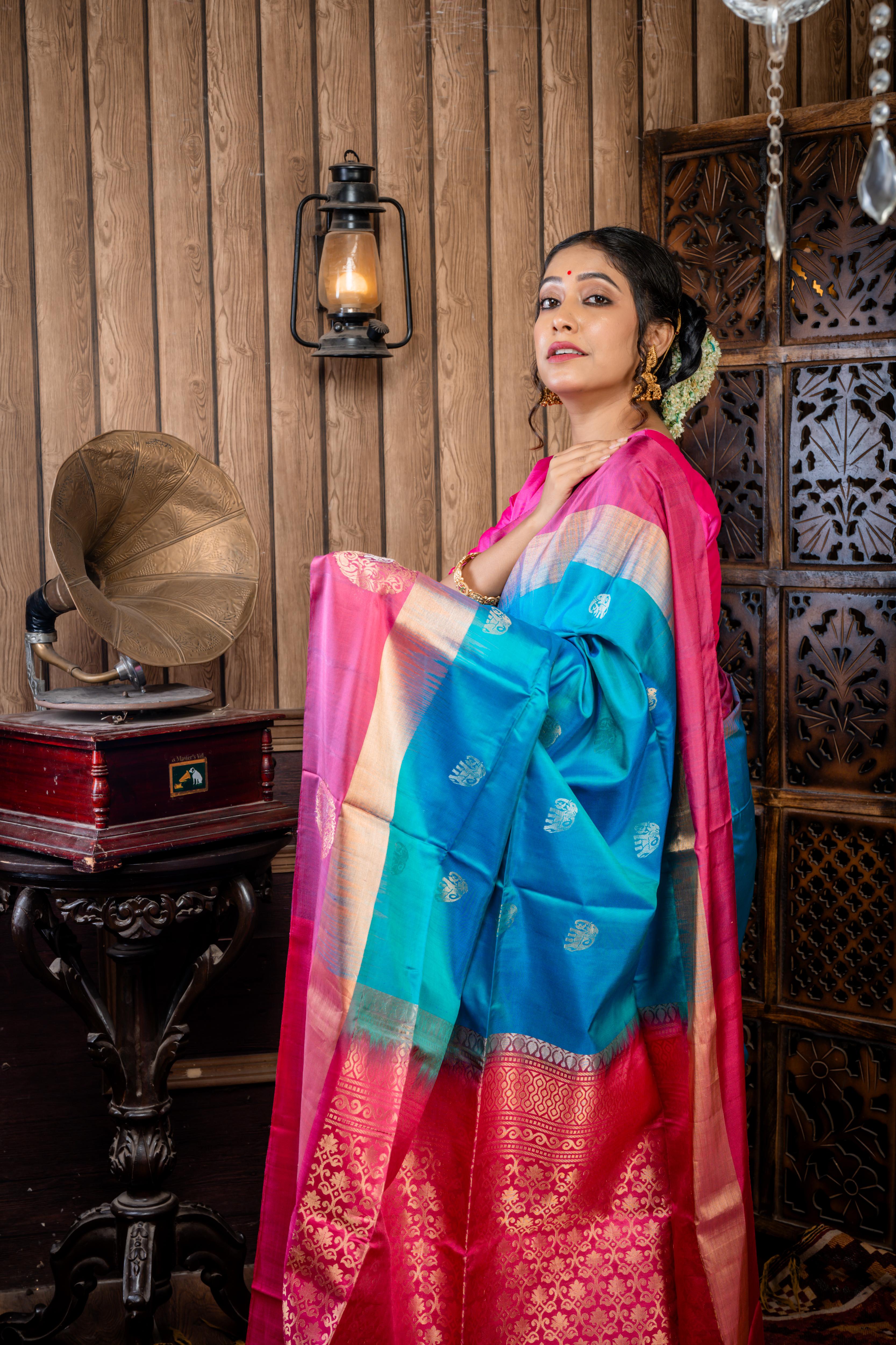 Iravathi || Turquoise Blue & Green dual tone Pattu Soft Silk Handloom Saree with all over Antique Gold & Silver Zari 'Elephant' motif Buta, Light Ruby Pink with 'Sona Rupa' Zari 'Elephant' motif & Antique Gold Zari Plain Border and Pallu