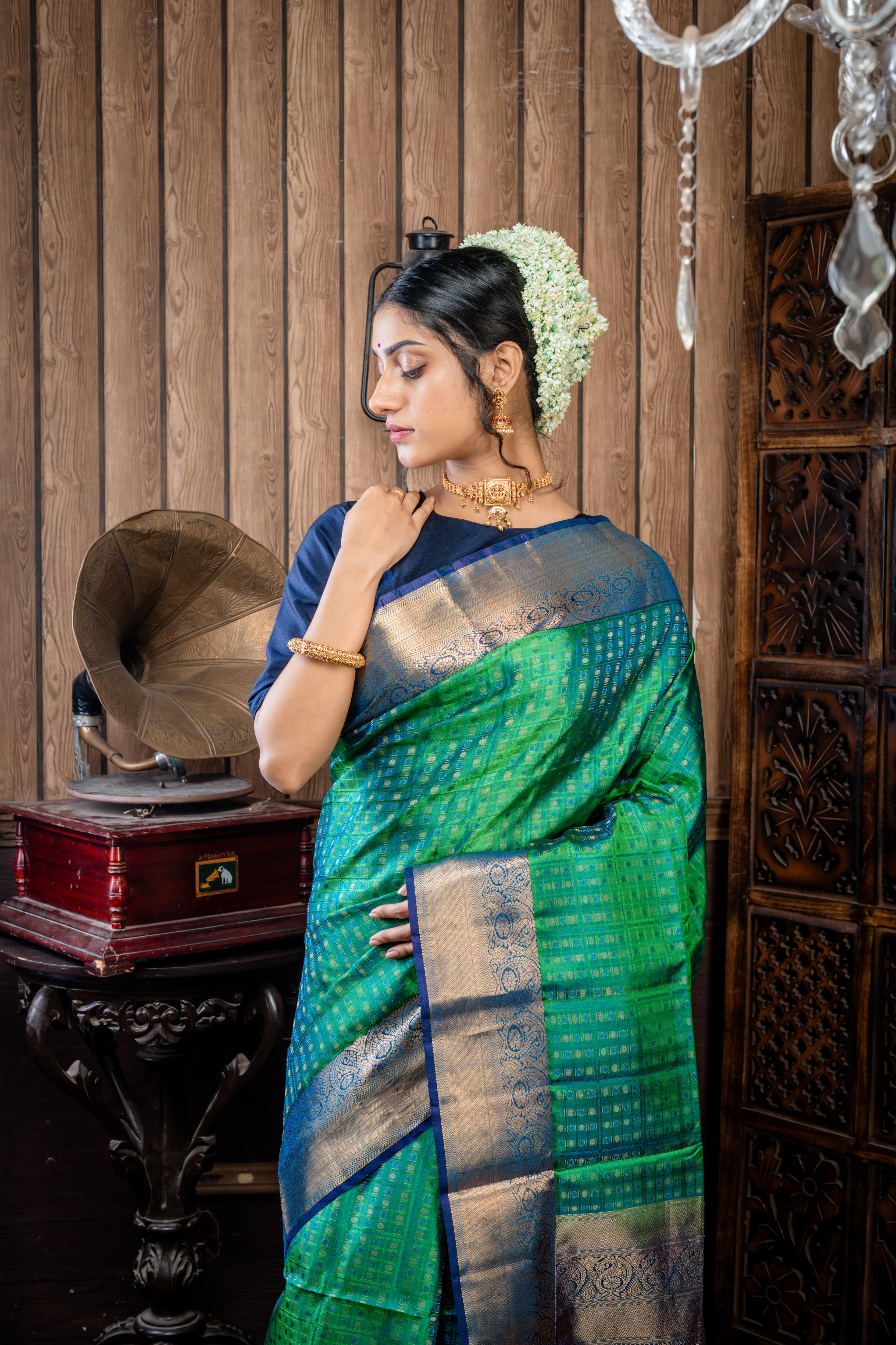 Shruthi || Leaf Green & Peacock Blue dual tone Pattu Soft Silk Handloom Saree with all over Antique Gold Zari, Peacock Blue Resham & Leaf Green Resham Buta & Checks and Violet & Peacock blue dual-tone with Antique Gold Zari Traditional Border & Pallu