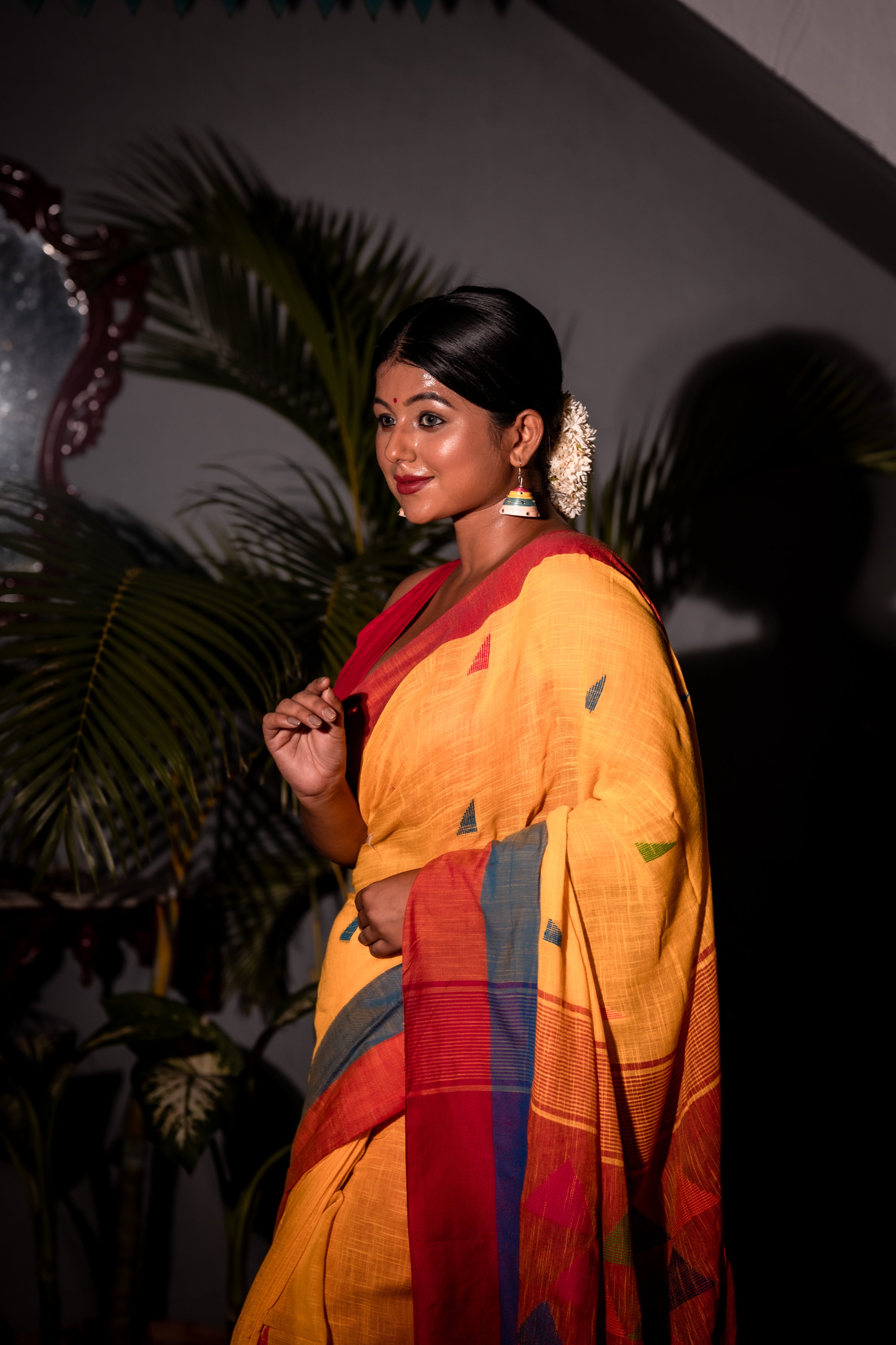 Tribeni || Turmeric Yellow Cotton Bengal Handloom Saree with all over Multi-colour Buta, Dusty Blue & Beet Red Border and 'Temple' motif Pallu