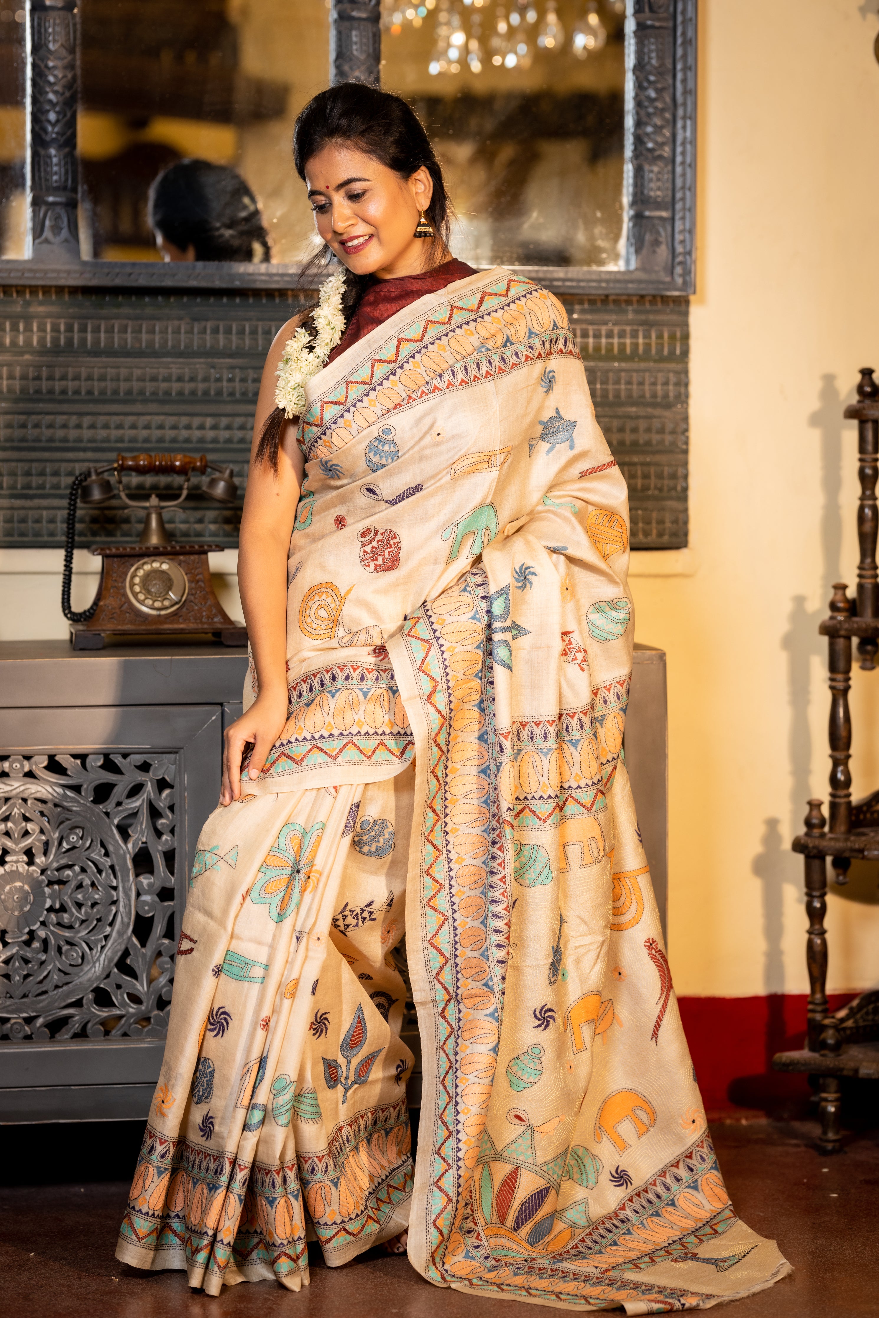 Mrittika || Light Beige Pure Gachhi Tussar Silk Handloom Kantha Stitch Embroidery Saree with all over Multi-colour Mixed Tribal Art motifs and Golden Resham highlights Pallu