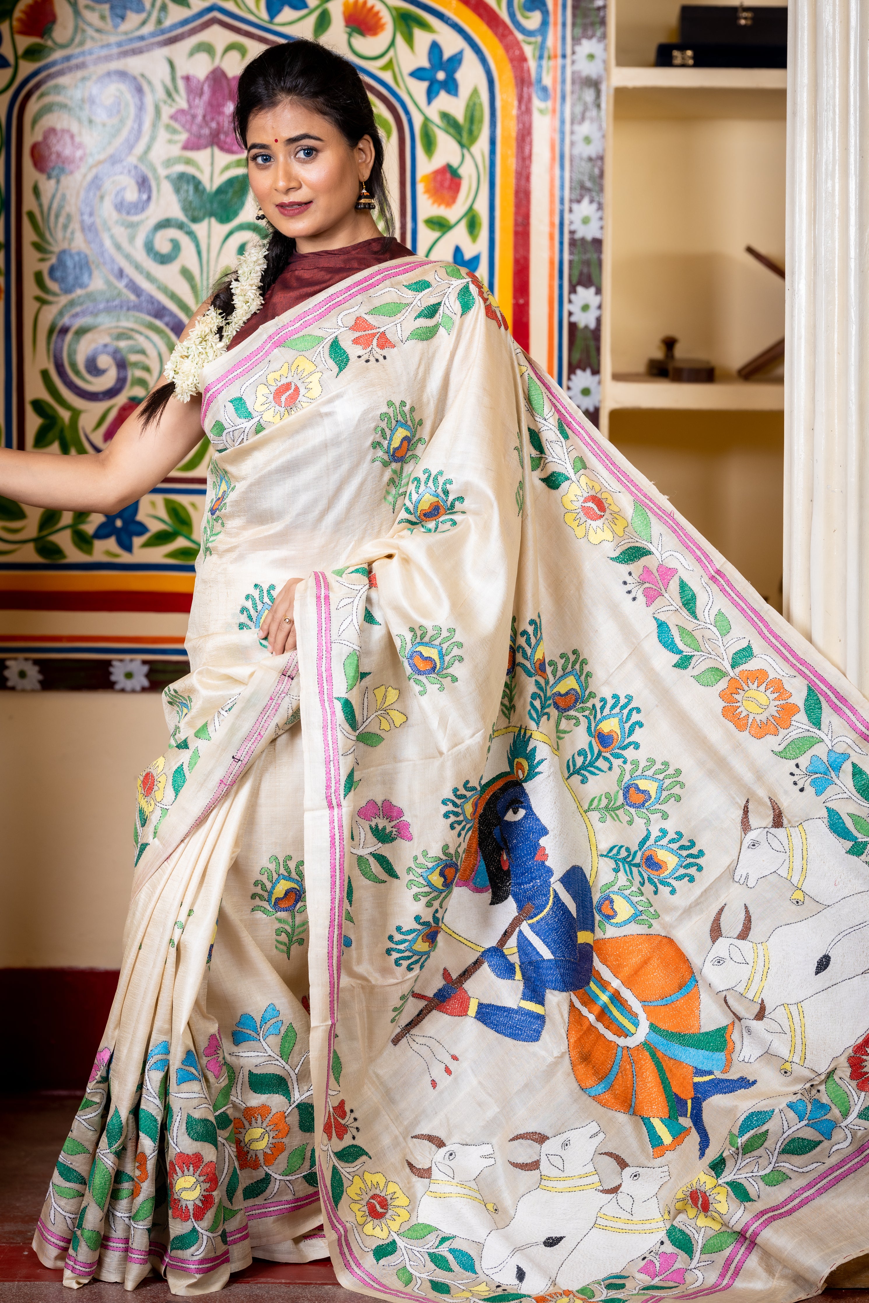 Brindabani || Beige Pure Gachhi Tussar Silk Handloom Kantha Stitch Embroidery Saree with all over Multi-colour 'Morpankh' motif Buta, Floral motif Border and 'Lord Krishna' theme Pallu