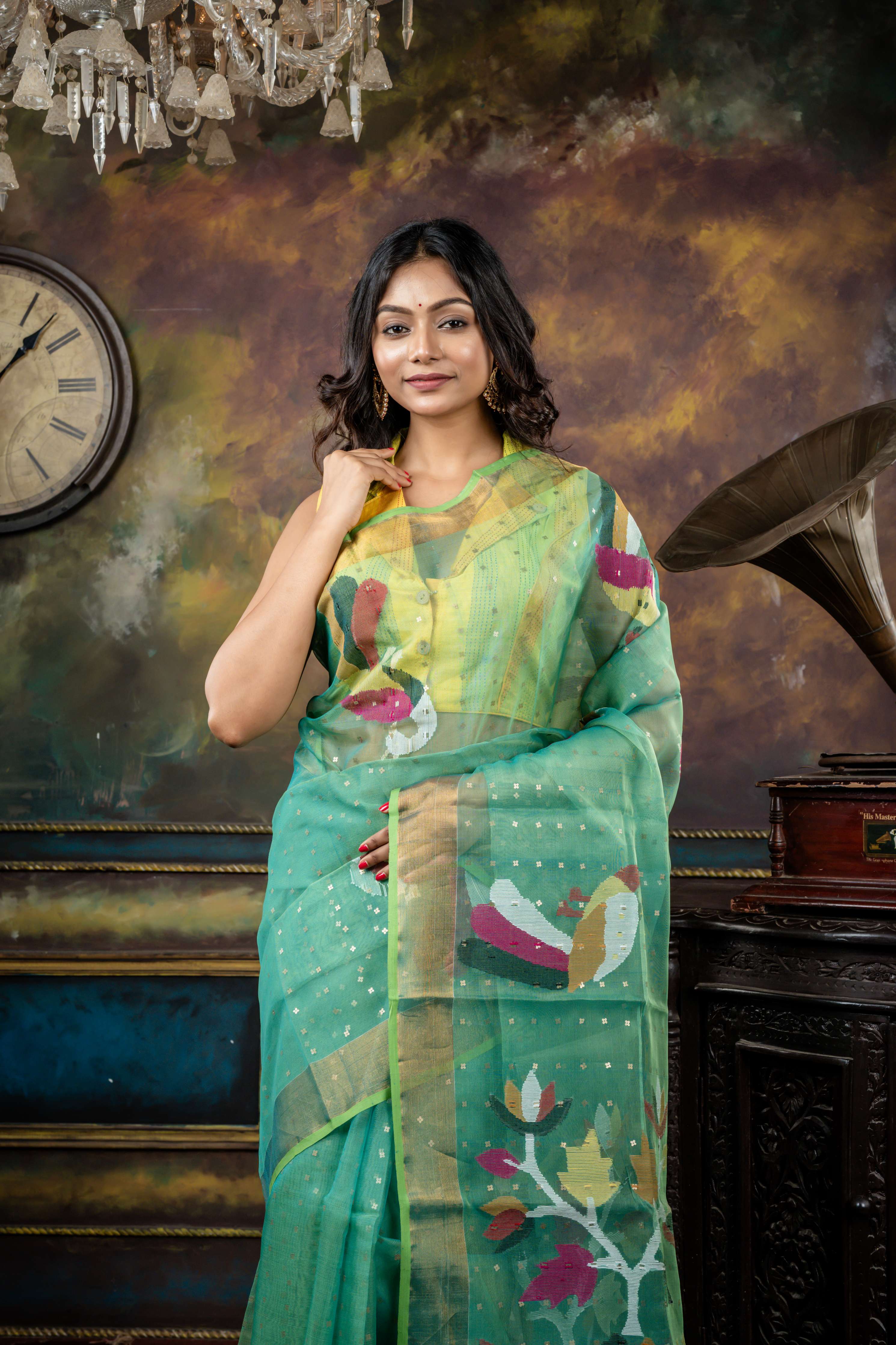 Vasuda || Parrot Green & Teal Green dual tone Premium Muslin Bengal Handloom Saree with all over woven Antique Gold Sequins, Multi-colour 'Peacock' motif & Antique Gold Zari Border and Floral Jamdani Pallu