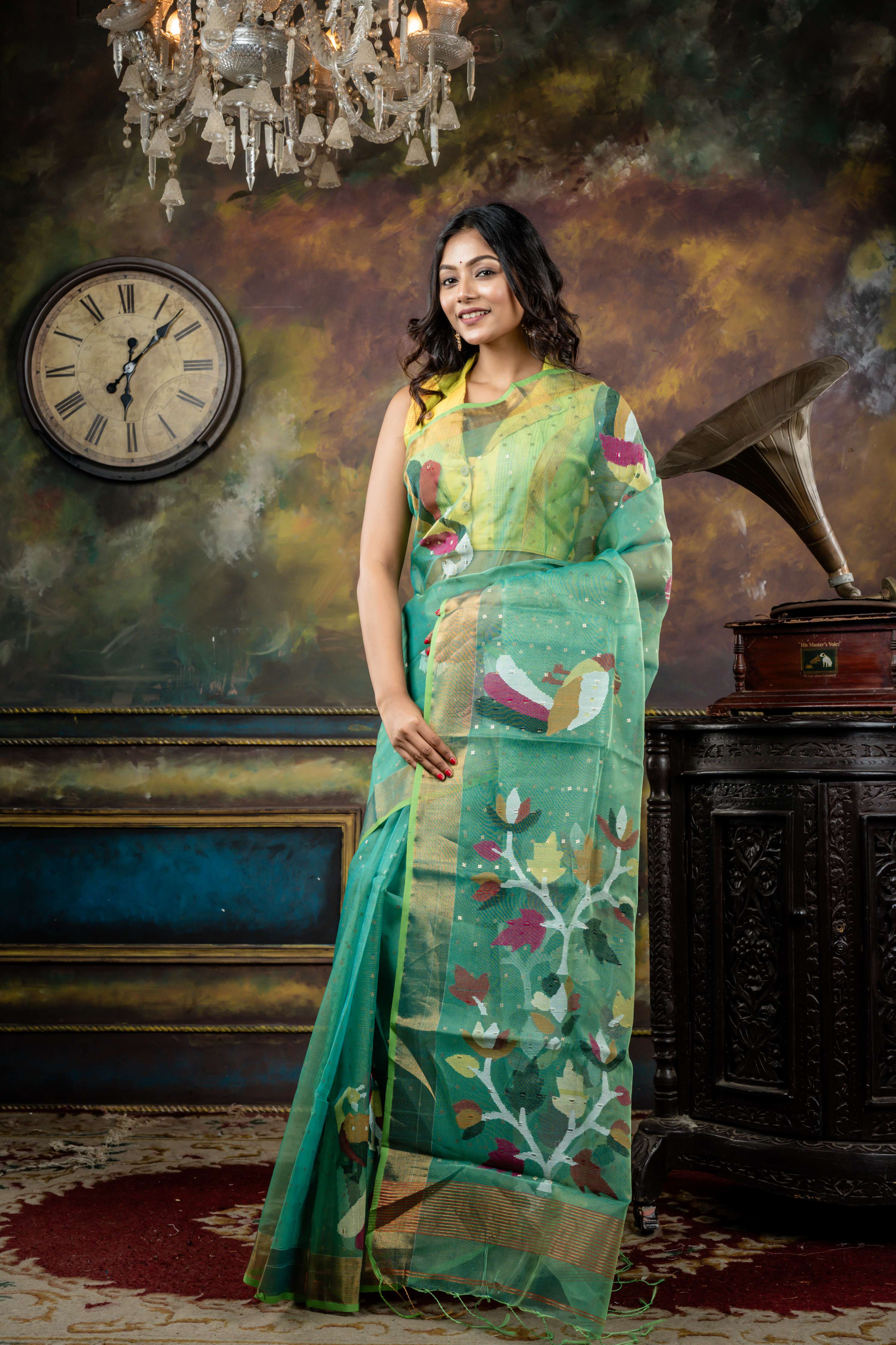 Vasuda || Parrot Green & Teal Green dual tone Premium Muslin Bengal Handloom Saree with all over woven Antique Gold Sequins, Multi-colour 'Peacock' motif & Antique Gold Zari Border and Floral Jamdani Pallu
