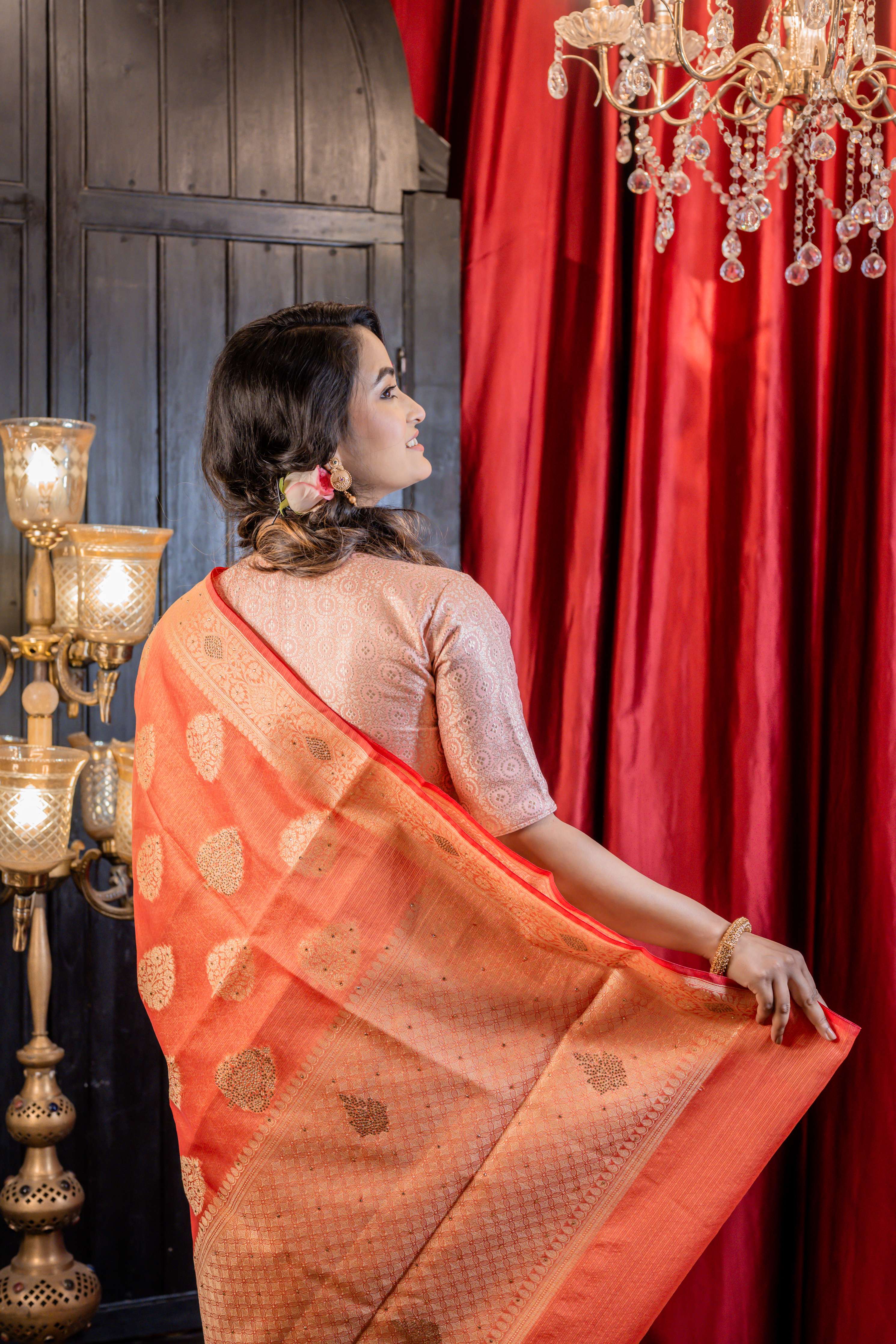 Ruchira || Brick Red Soft Silk Banarasi Saree with all over Matte Gold Zari Floral Buta, Brocade Pallu and Gold Rhinestone bead highlights