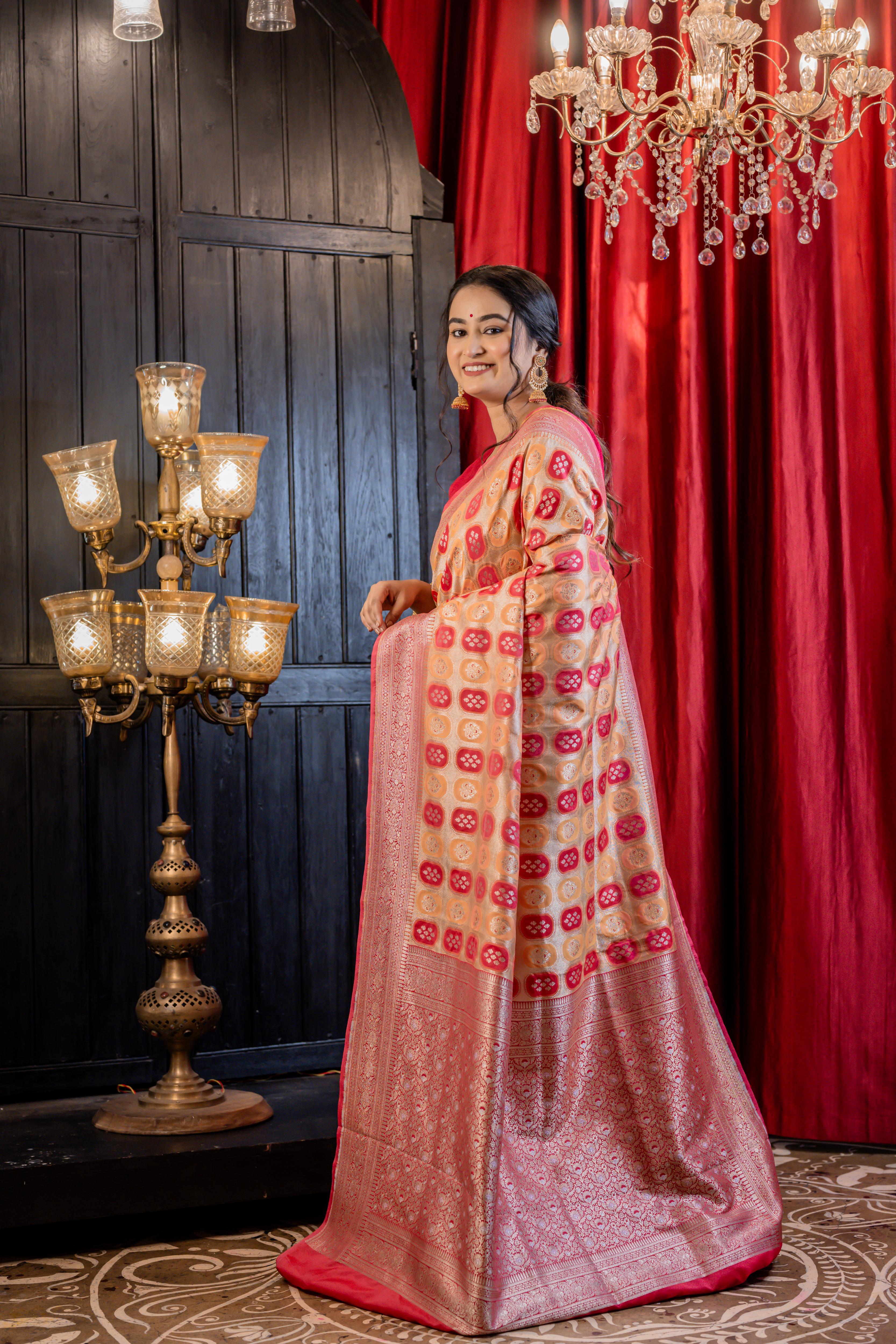 Abha || Woven Matte Gold Zari base Matka Silk Banarasi Saree with all over Peach & Raspberry Red Capsule shape Buta and Meenakari Floral highlights
