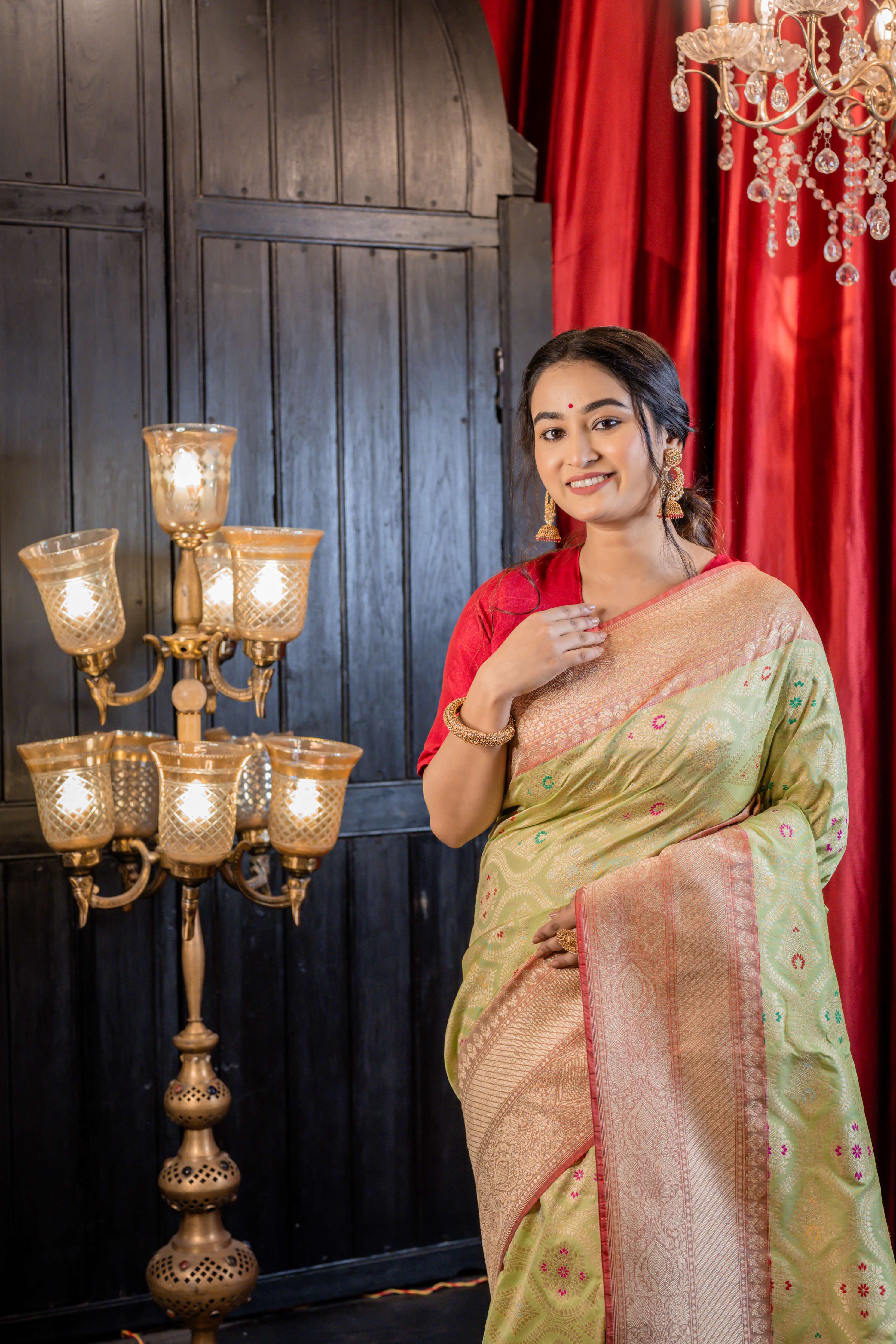 Palashini || Pista Green Matka Silk Banarasi Saree with Multi-colour Meenakari highlights, all over Jaal woven in Matte Gold Zari and Pale Orange border