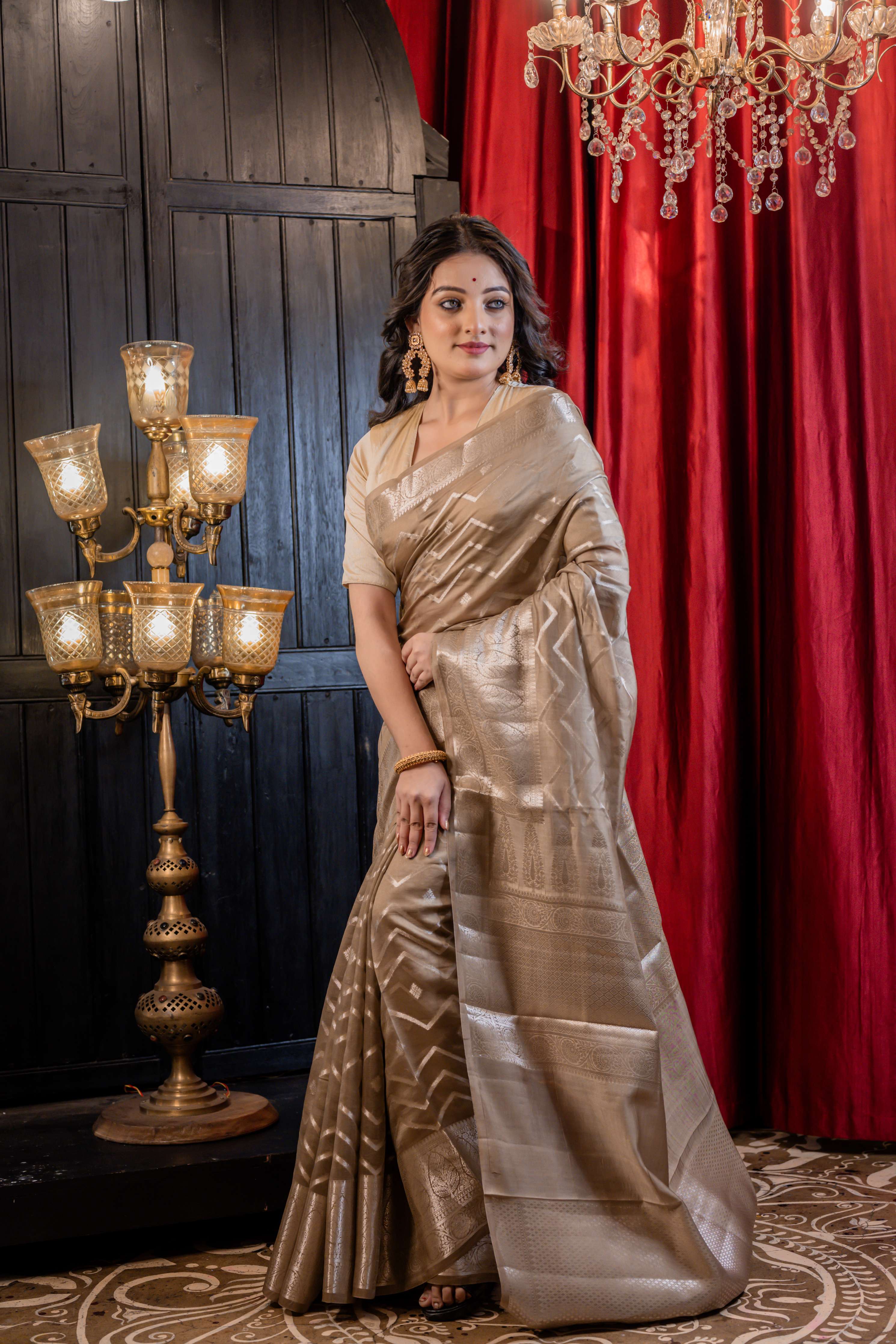 Urmika || Medium Taupe Brown Chinia Silk Banarasi Saree with all over Buta & Stripe Pallu woven in Silver Zari