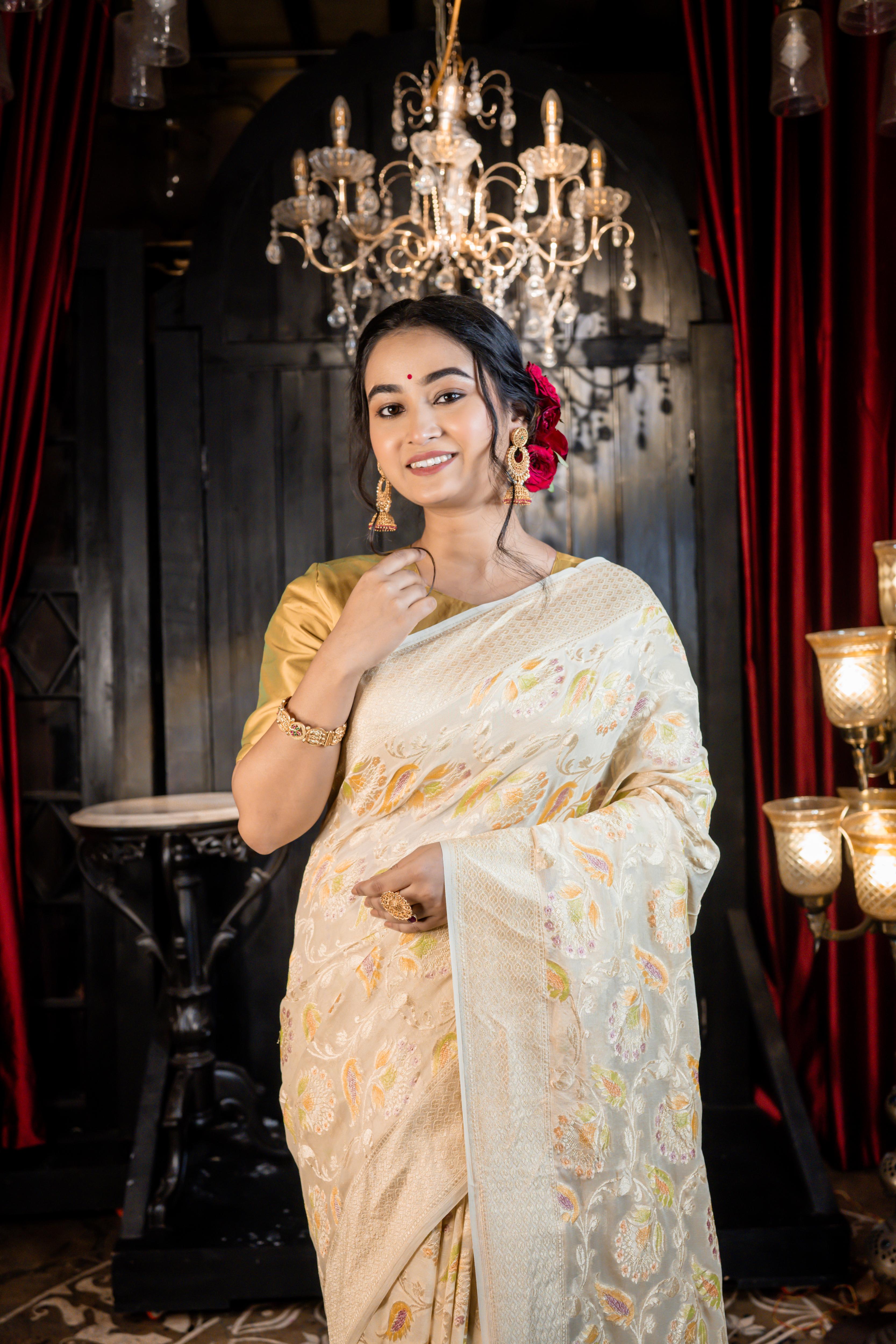 Iva || Ivory Khaddi Georgette Banarasi Saree with all over Rifling Handbrush Multi-colour & Matte Gold Zari Floral motif Jangla