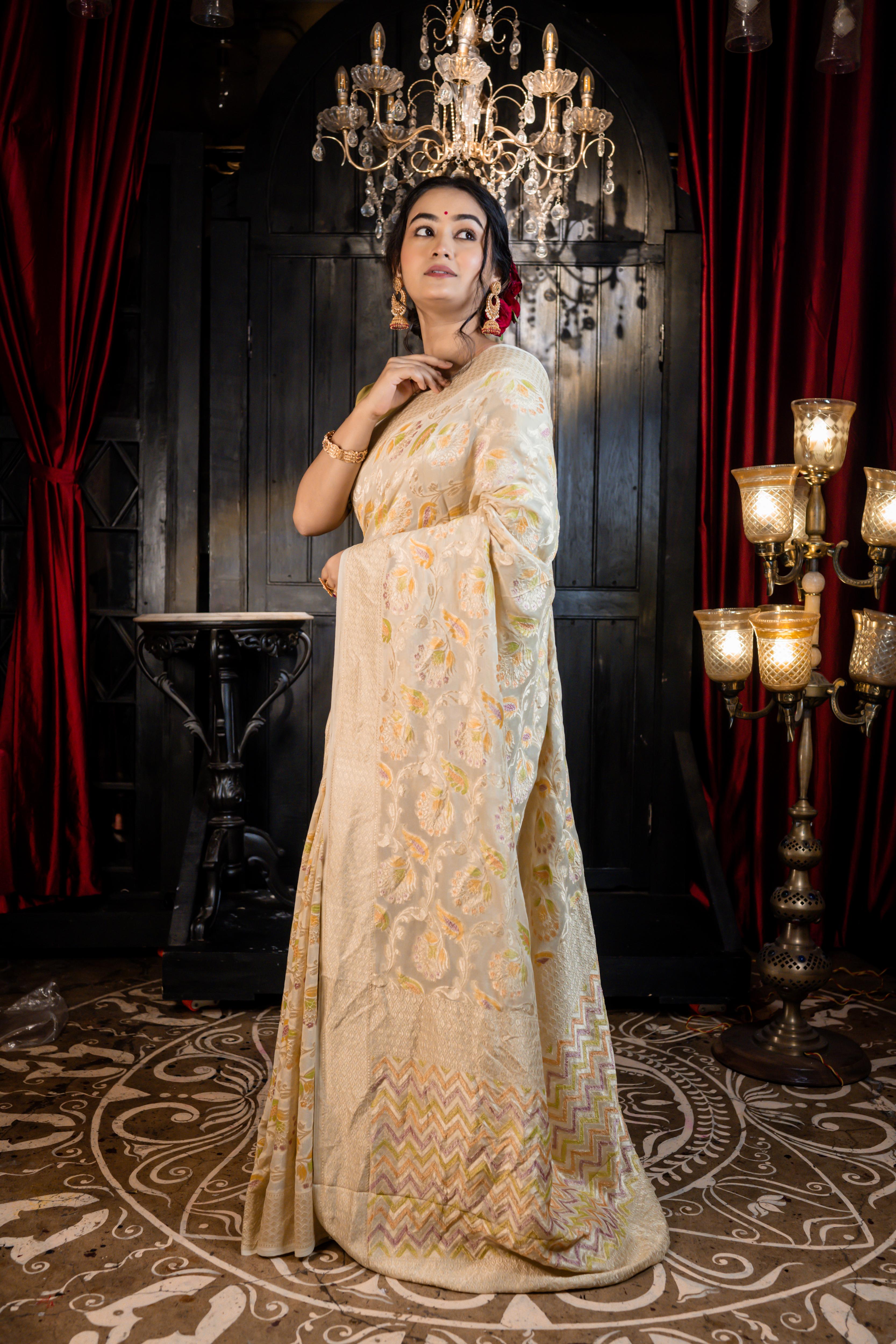 Iva || Ivory Khaddi Georgette Banarasi Saree with all over Rifling Handbrush Multi-colour & Matte Gold Zari Floral motif Jangla