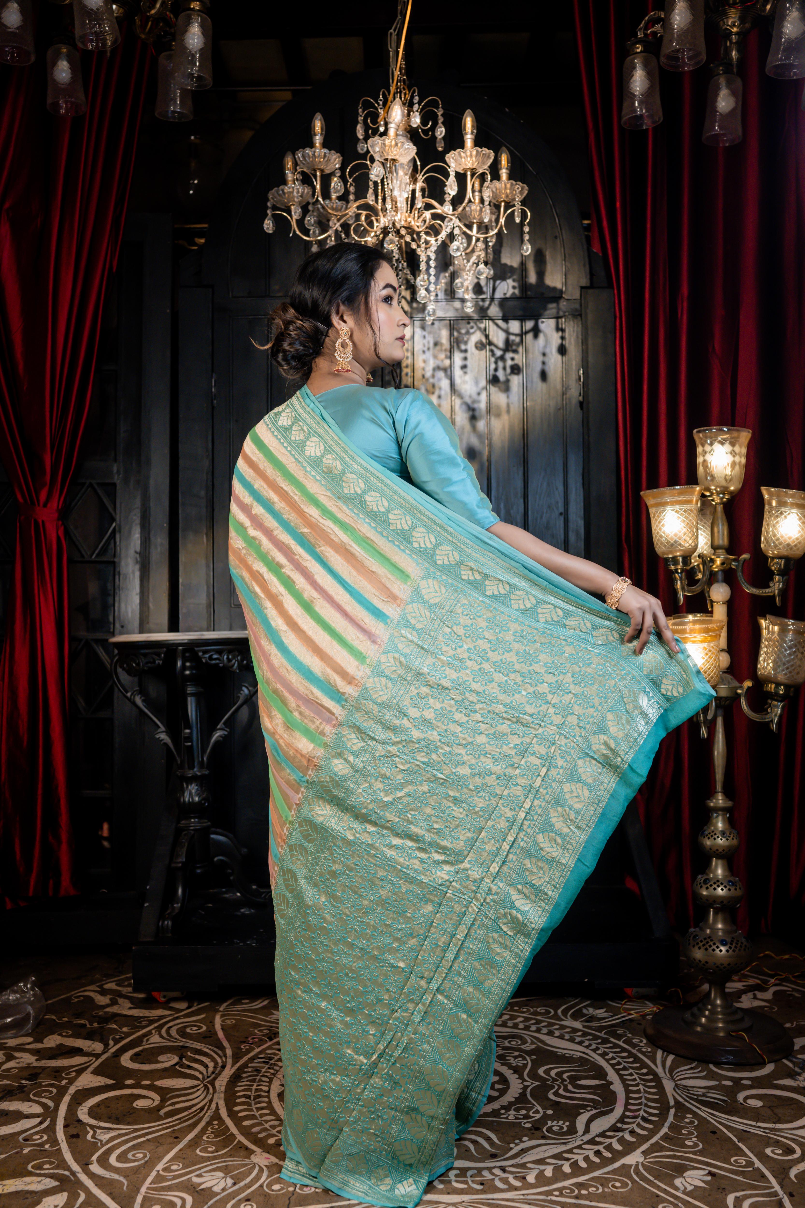 Leheri || All over Rifling Handbrush Multi-coloured & Matte Gold Zari woven Stripes Khaddi Georgette Banarasi Saree with Sky Blue & Matte Gold Zari border