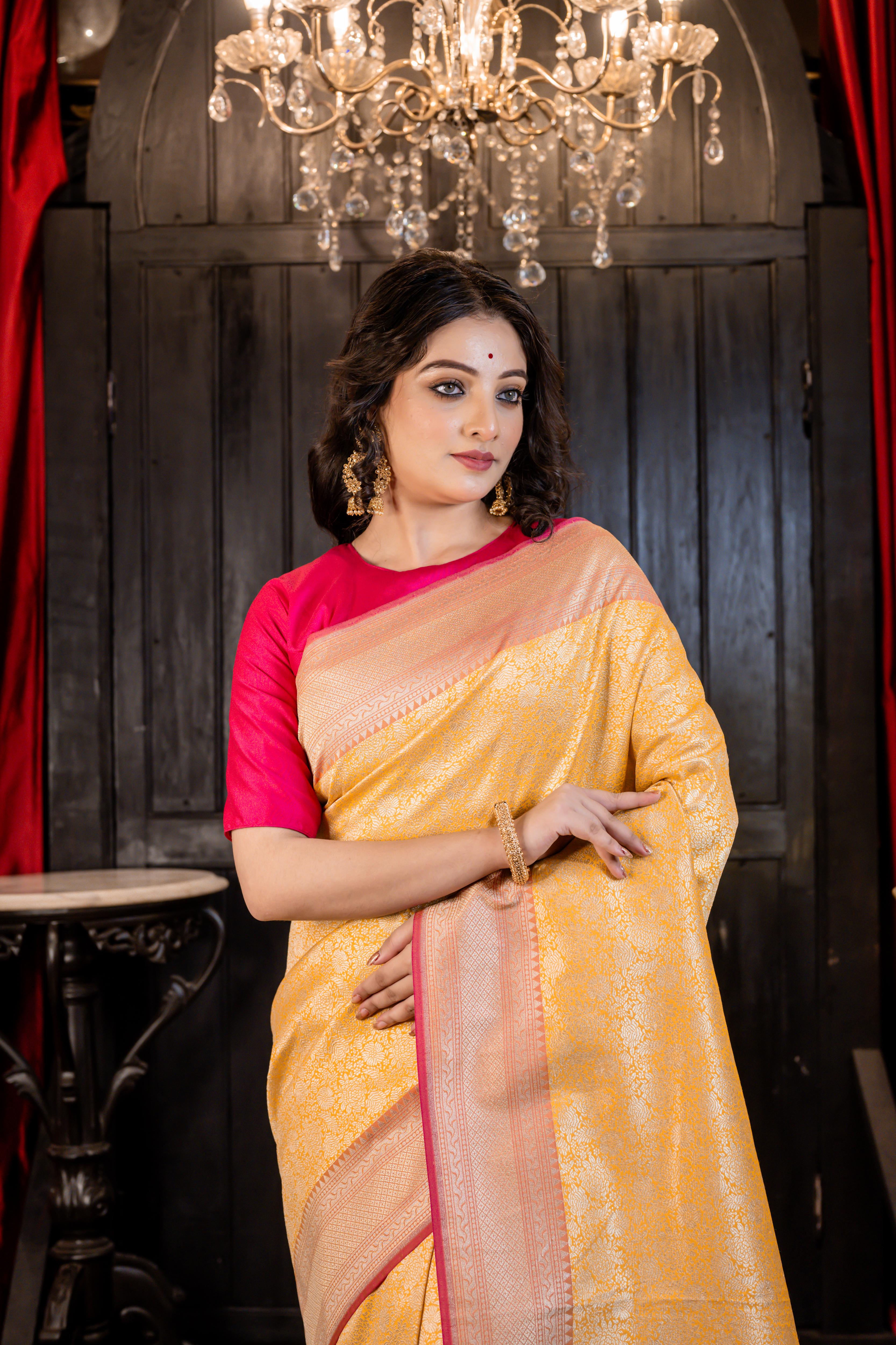 Aruni || Turmeric Yellow Matka Silk Banarasi Saree with all over Floral Jangla woven in Matte Gold Zari and Peach Pallu