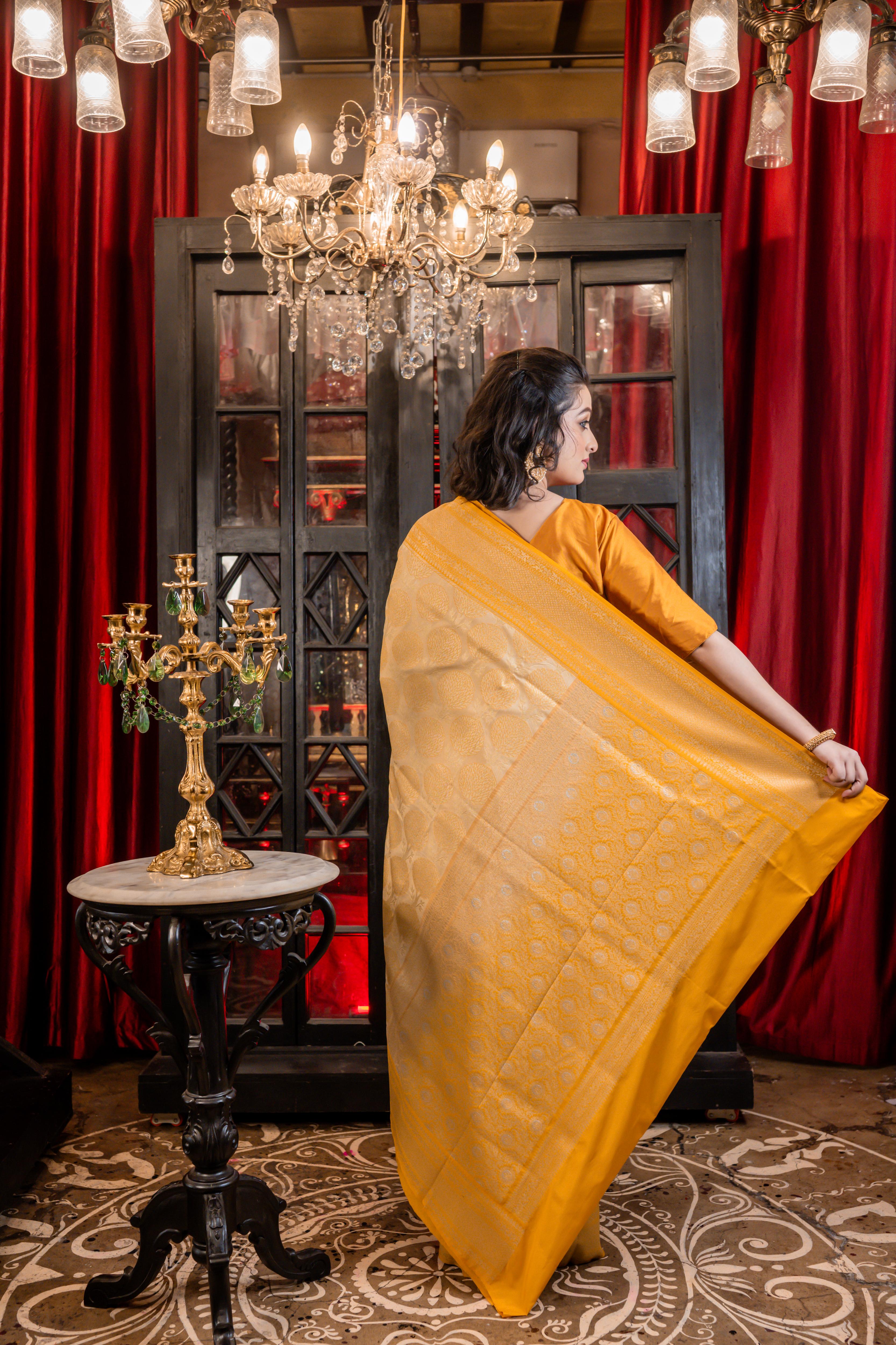 Varnika || Beige Base Matka Silk Banarasi Saree with Mango Yellow border and all over Tree motif woven in Matte Gold Zari