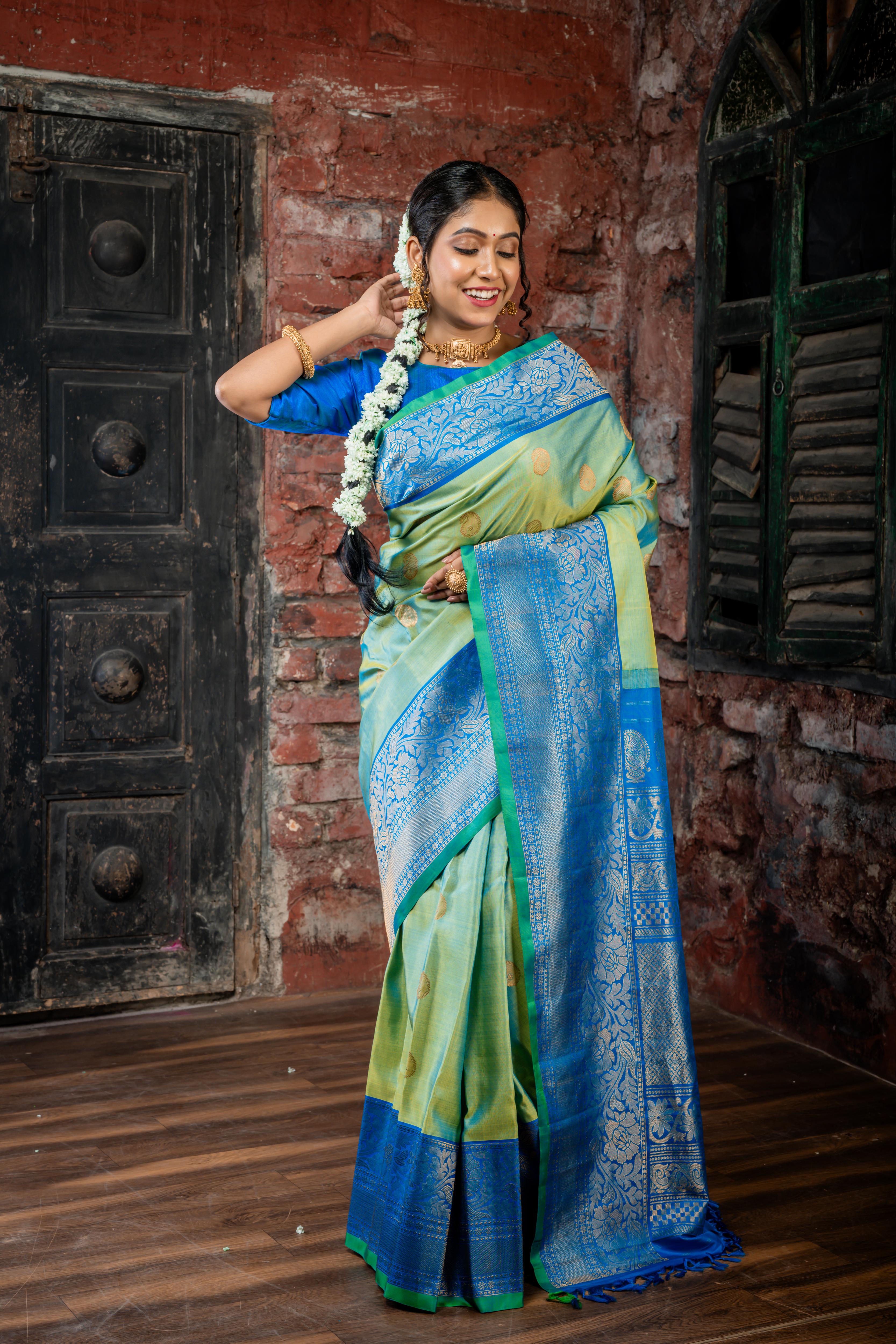 Narayani || Olive Green & Peacock Blue dual tone Pure Gadwal Silk Handloom Saree with all over Antique Gold Zari 'Kalka' Buta; Peacock Blue, Green & Antique Gold Zari Traditional design Border and Brocade Pallu