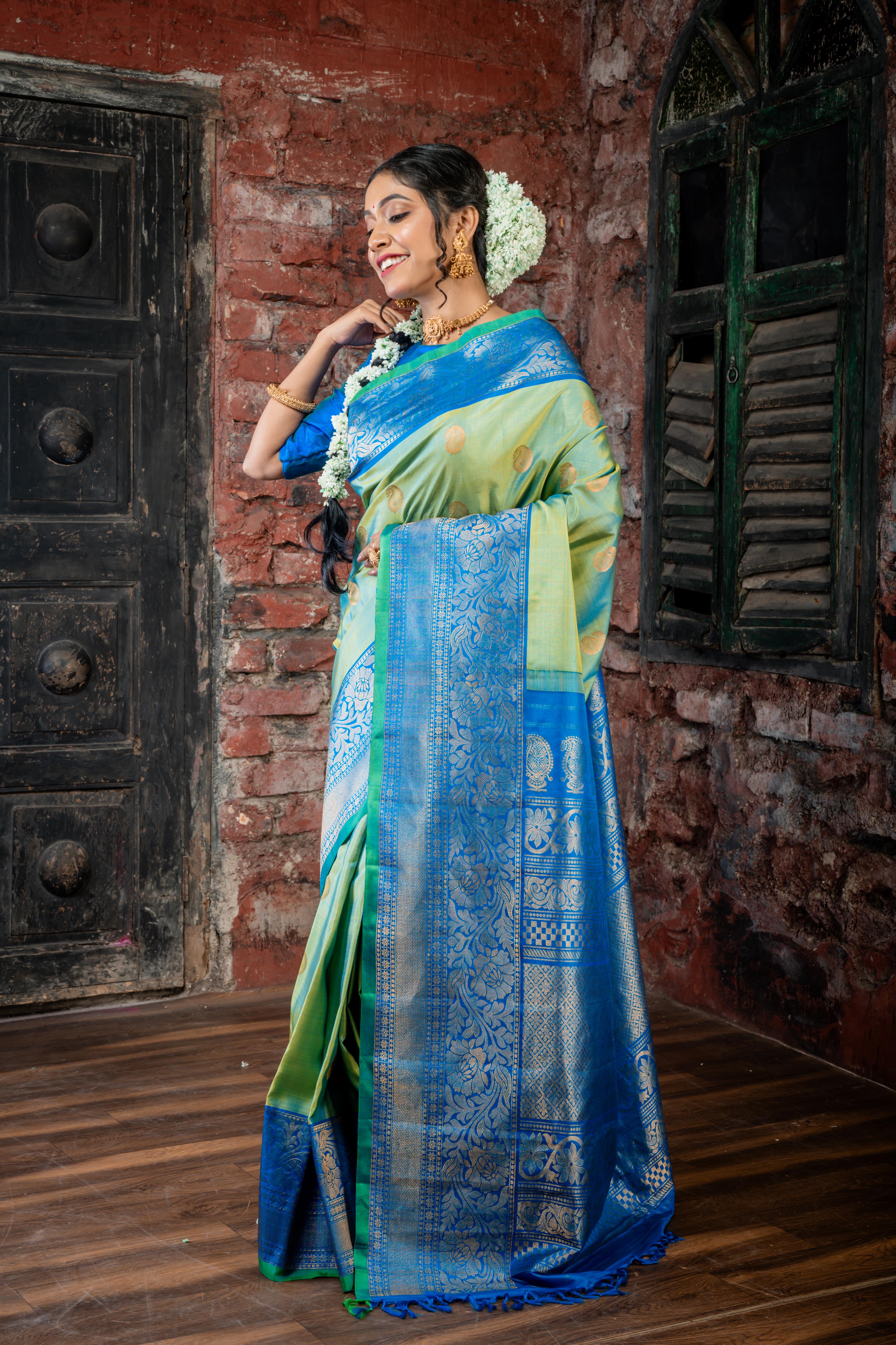 Narayani || Olive Green & Peacock Blue dual tone Pure Gadwal Silk Handloom Saree with all over Antique Gold Zari 'Kalka' Buta; Peacock Blue, Green & Antique Gold Zari Traditional design Border and Brocade Pallu
