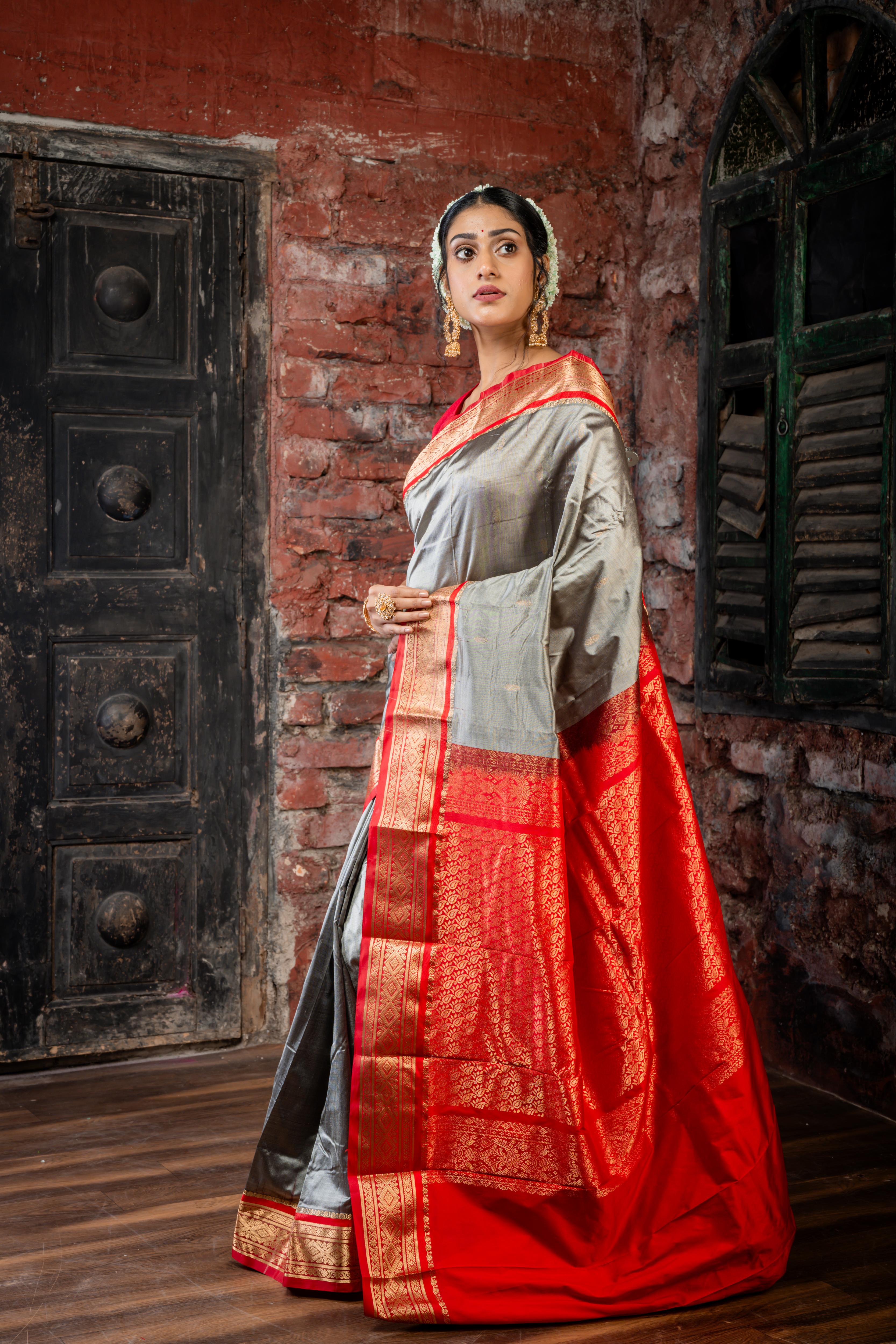 Amala || Smokey Grey Kanjivaram Silk Saree with all over Matte Gold Zari Buti, Red & Matte Gold Zari Border and Red Pallu in Matte Gold Zari Traditional 'Kalka' design